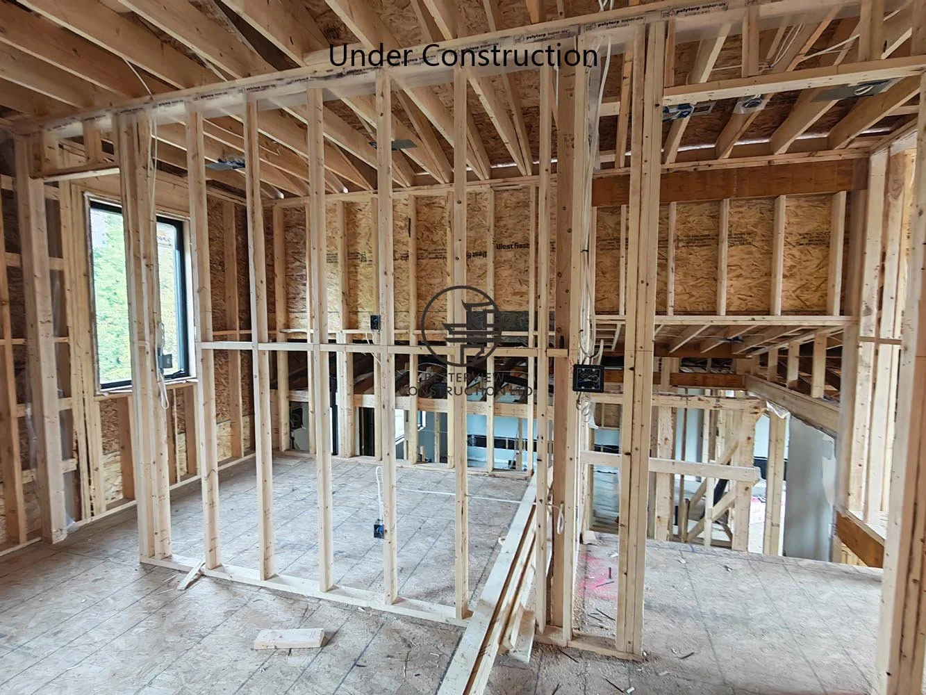 Interior wood framing for a custom home addition, showcasing structural wall framing and open concept layout construction in Toronto.