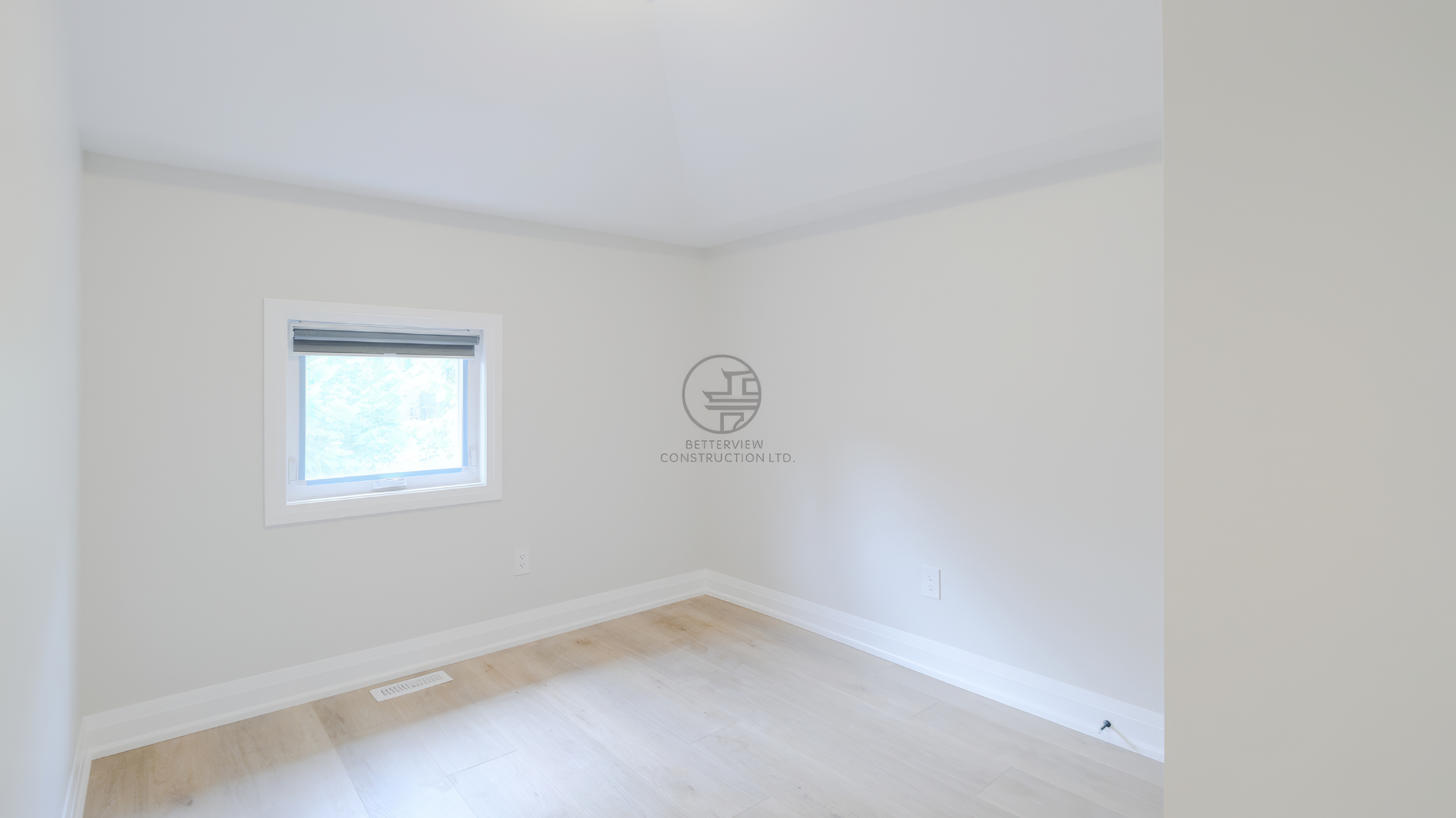 main-floor-bedroom-white-walls-wood-flooring.jpg.png