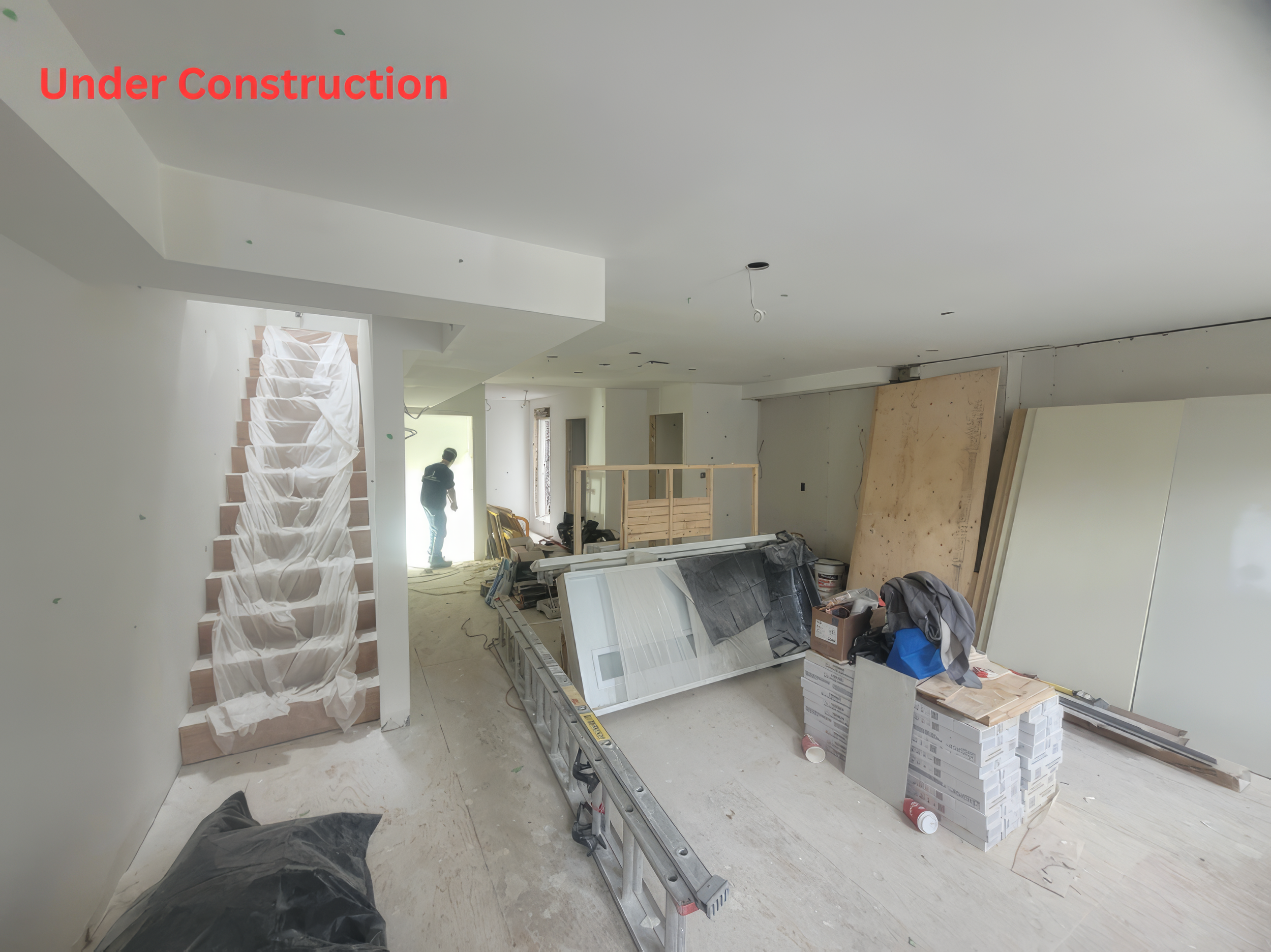 Home renovation under construction in Toronto showing open concept layout, staircase work, and interior framing in progress