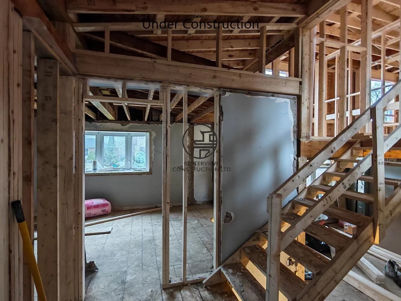 Interior framing and new staircase construction during a full home renovation and second floor addition in Toronto.