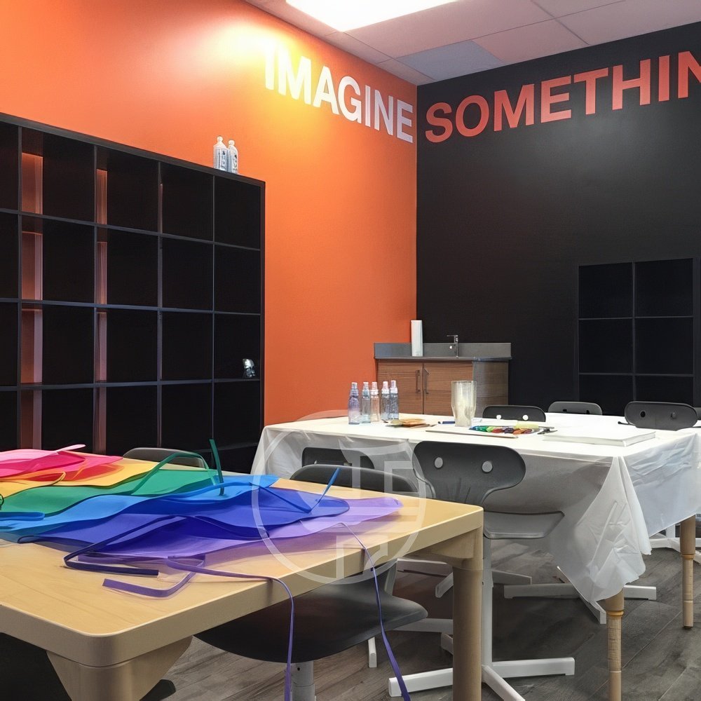 Creative commercial interior design in Toronto featuring branded walls, collaborative workspace, and modern education or studio environment