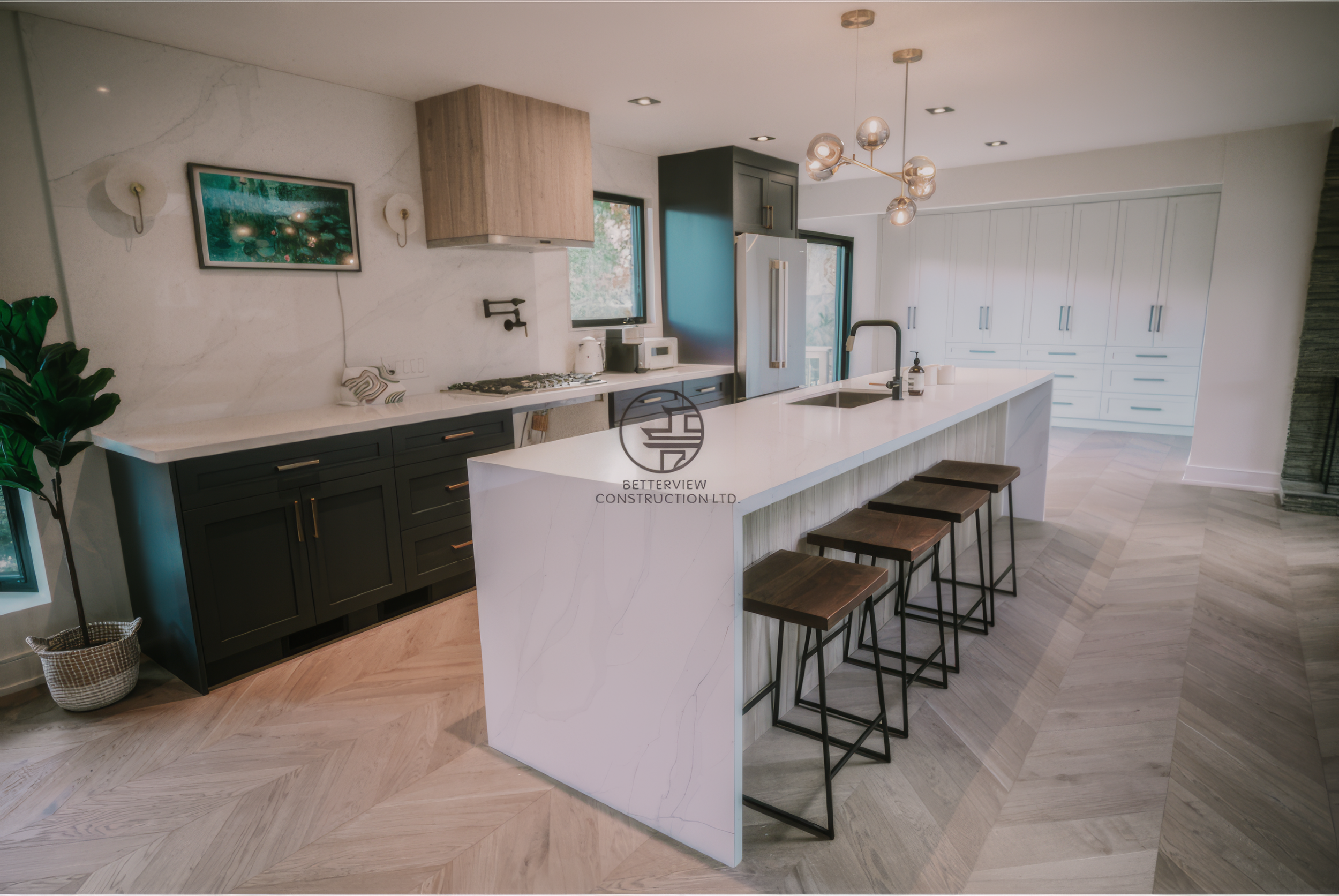 Modern kitchen renovation with large waterfall island, bar seating, and custom cabinetry in a Toronto home.