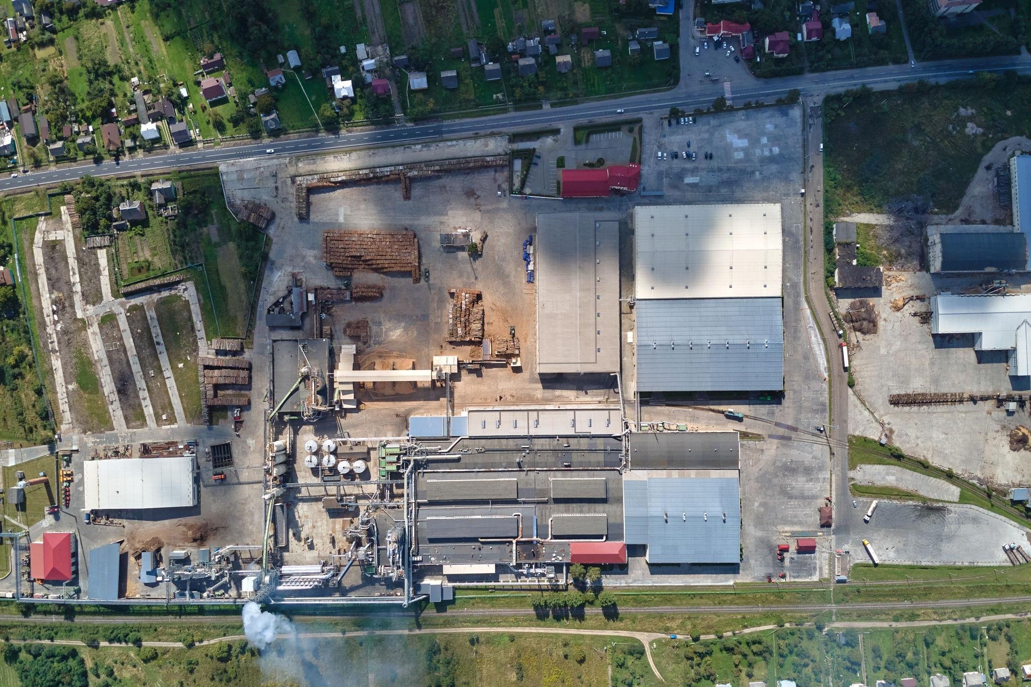 Aerial view of industrial factory site with production buildings, storage areas, and facility layout