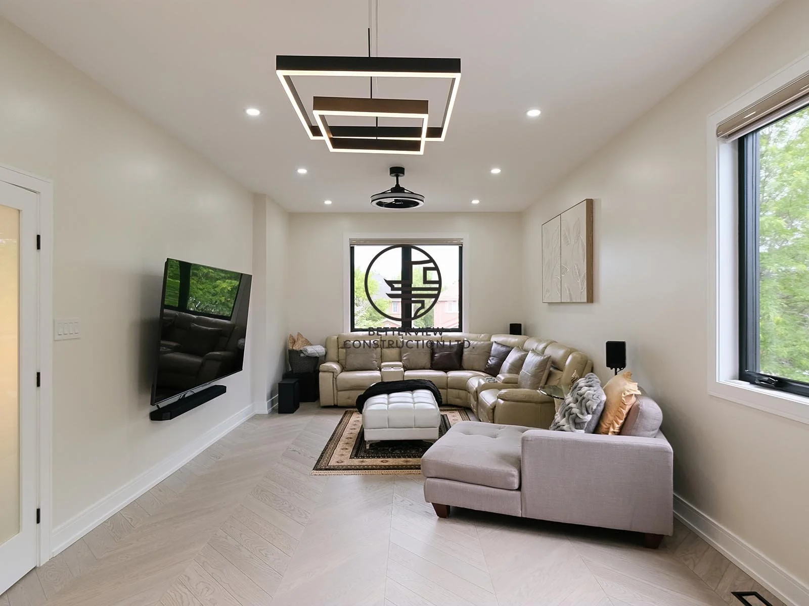 This spacious family room offers an open-concept layout, large windows, and contemporary finishes, providing a comfortable space for relaxation and everyday living.
