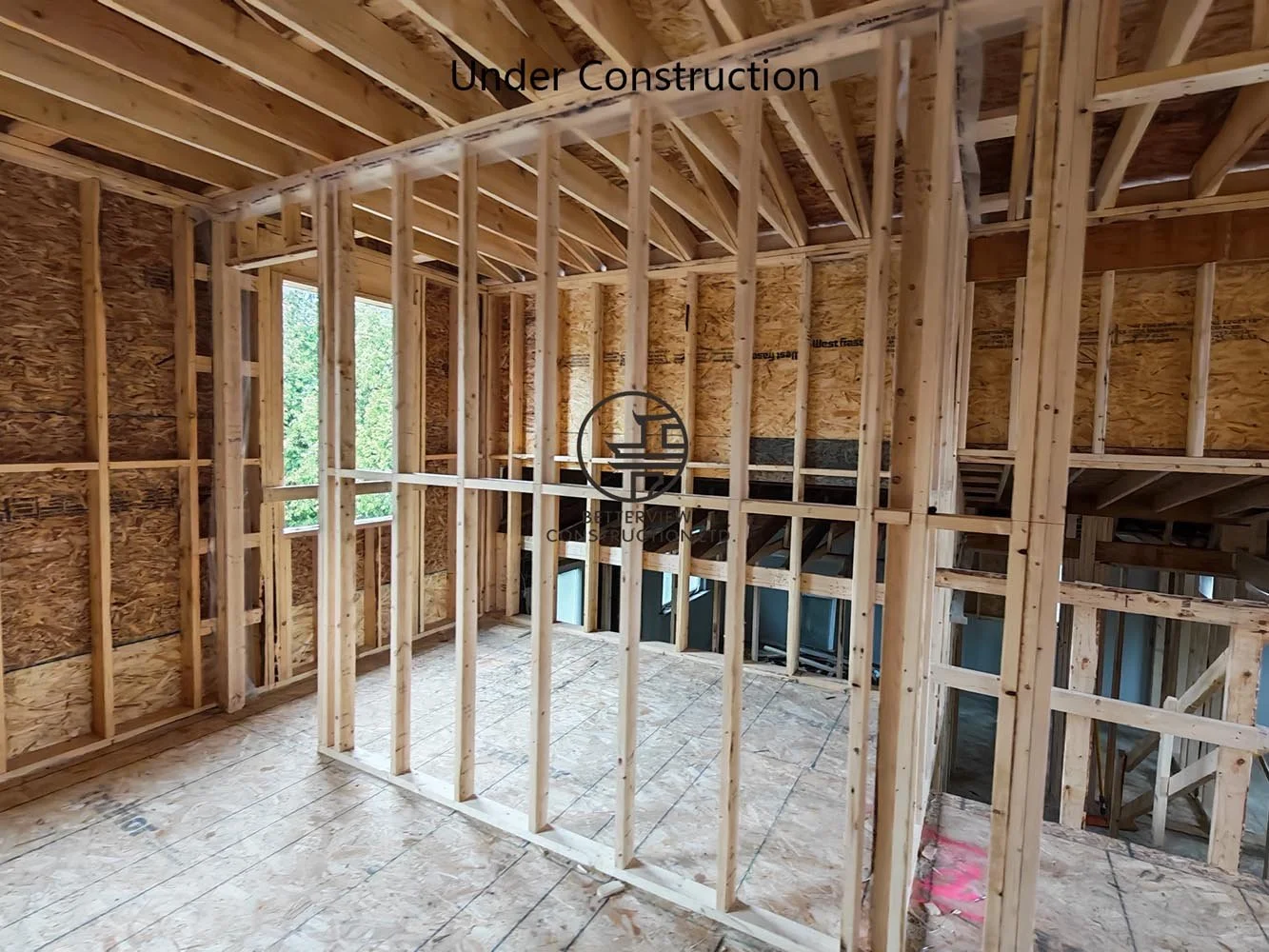 Wood stud wall framing for a custom home addition, preparing the interior for electrical, plumbing, insulation, and drywall installation.