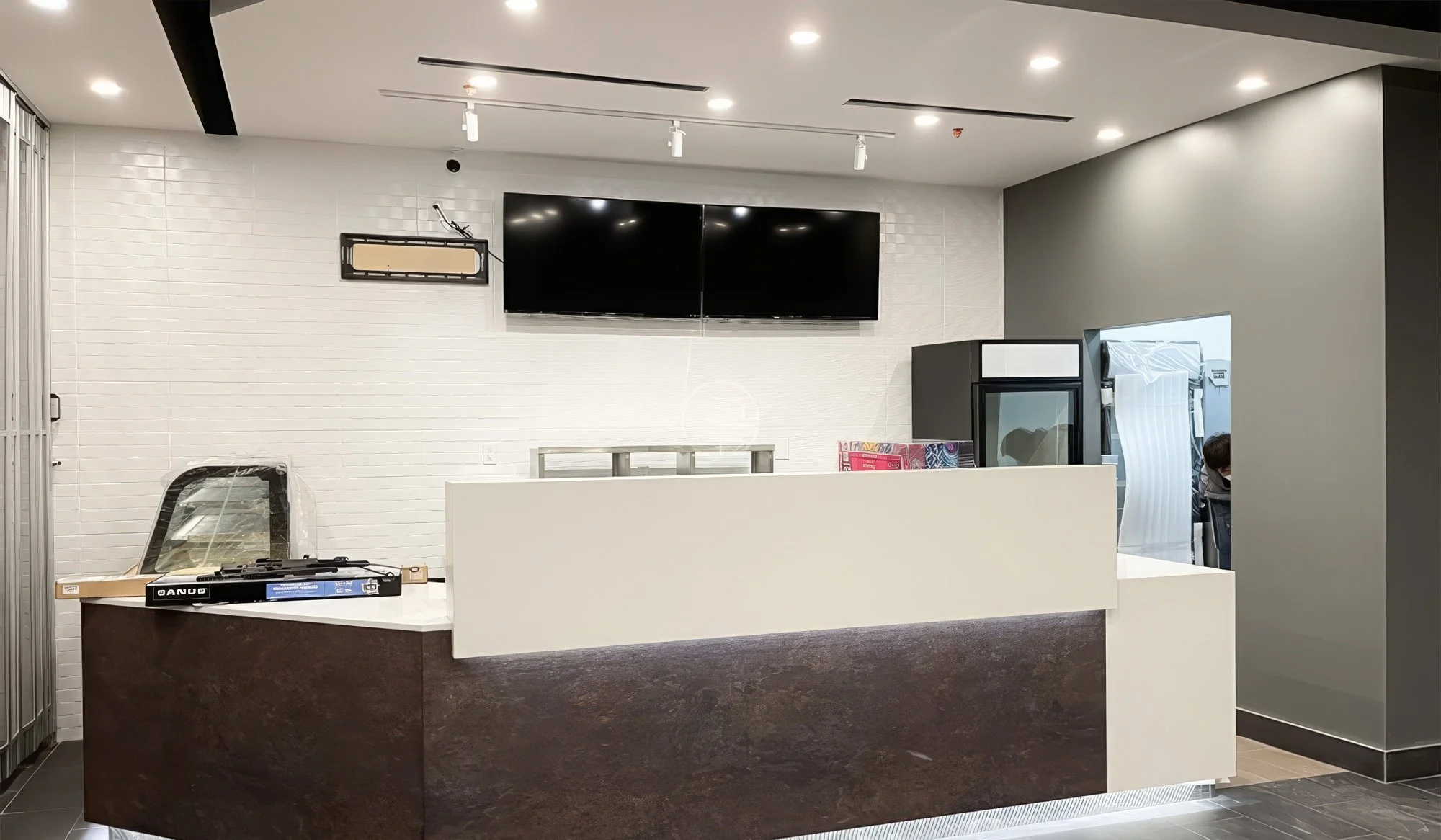 Modern retail store renovation in Toronto featuring reception counter, open floor layout, and contemporary commercial interior design
