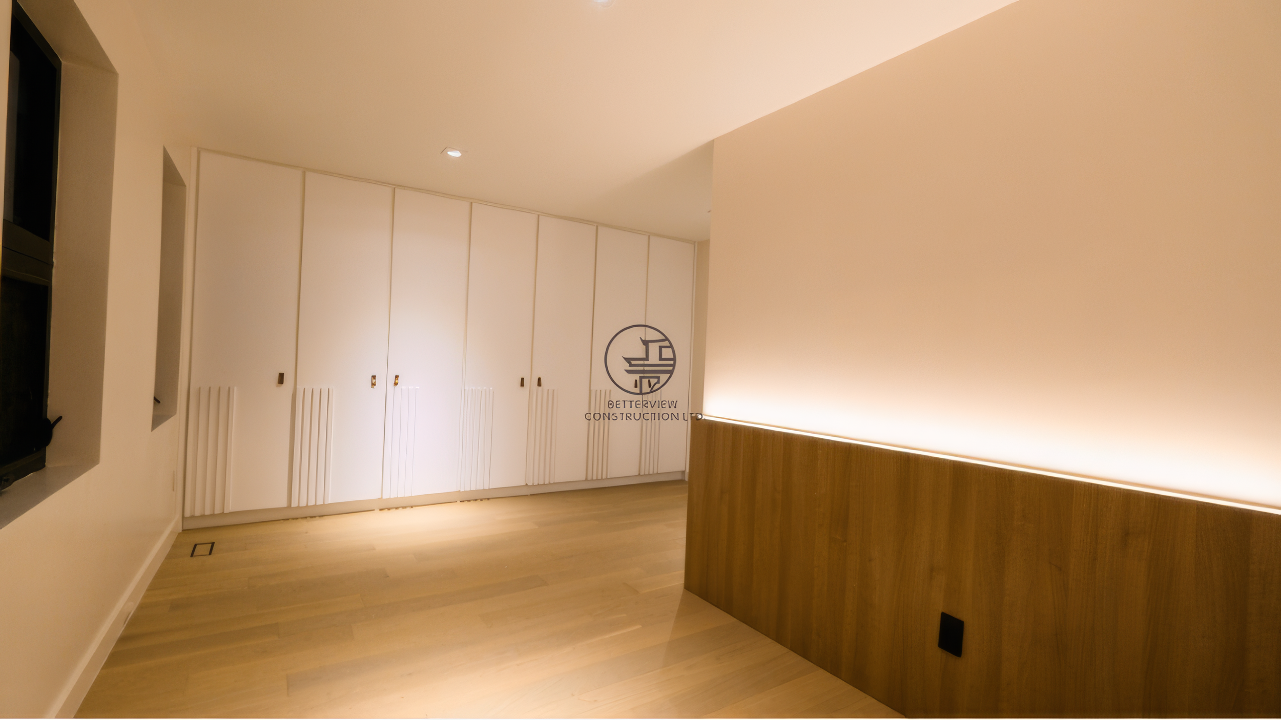 modern bedroom renovation with custom white wardrobes, wood panel accent wall, and ambient lighting