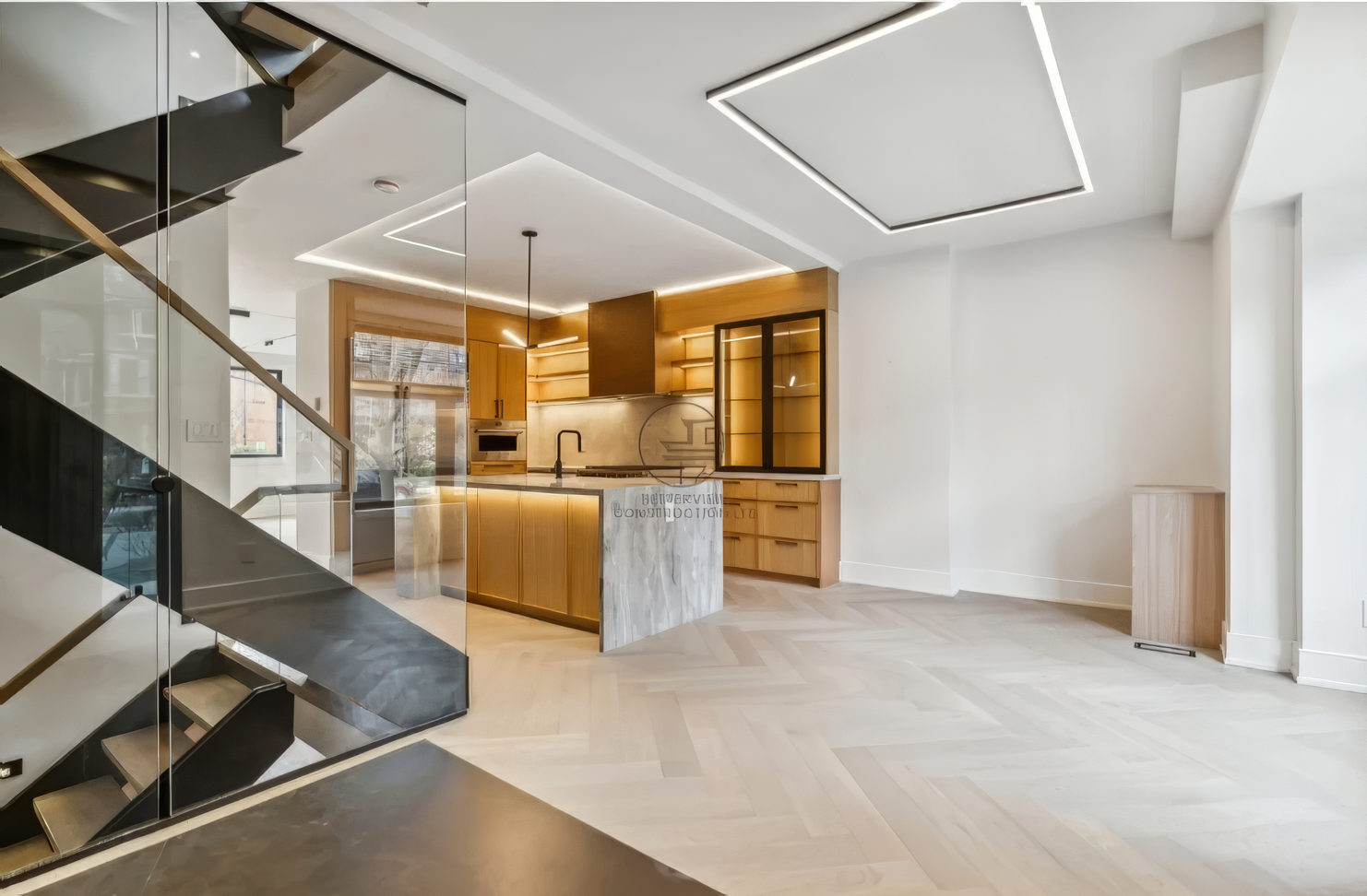 Modern open-concept kitchen with marble island, glass staircase, wood cabinetry, and geometric LED ceiling lighting in contemporary home interior.