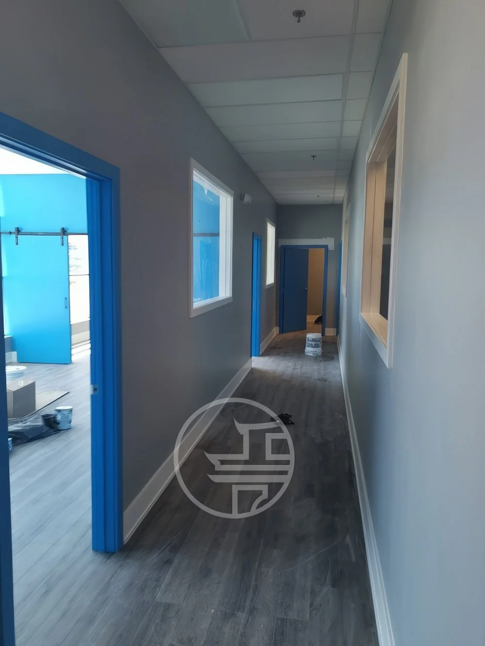 Commercial office hallway renovation with completed flooring, door frames, and interior finishing work in Toronto corridor space
