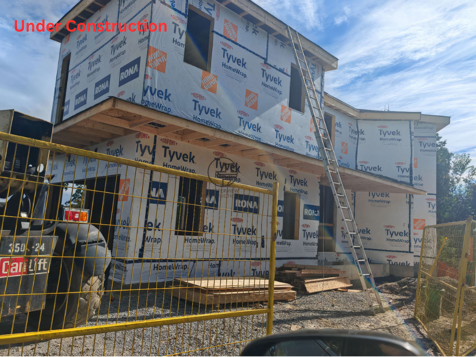 Under construction new home with Tyvek wrap, second floor addition and exterior framing in progress
