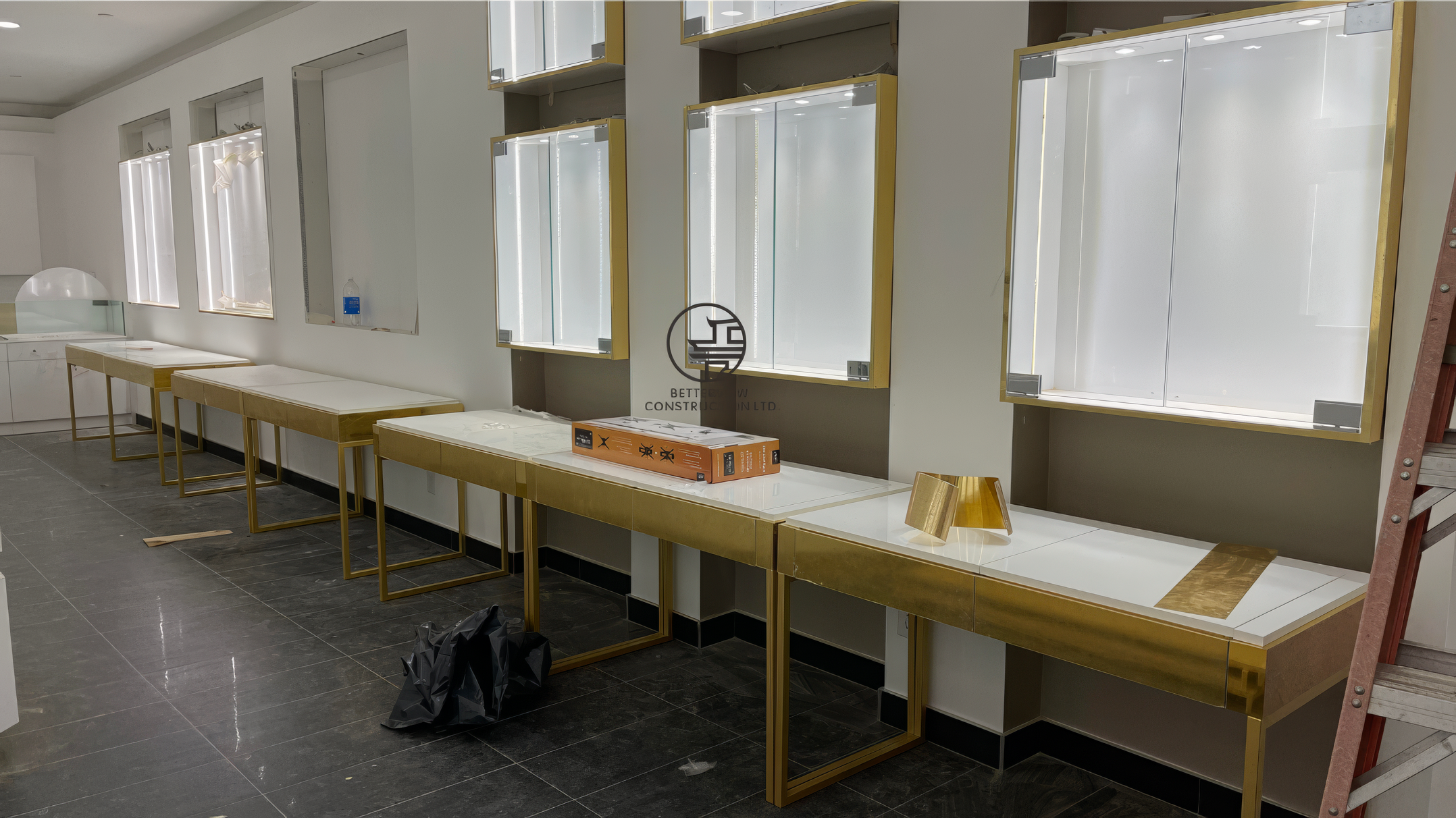Luxury retail display wall with gold fixtures and illuminated showcases during jewelry store renovation in Toronto