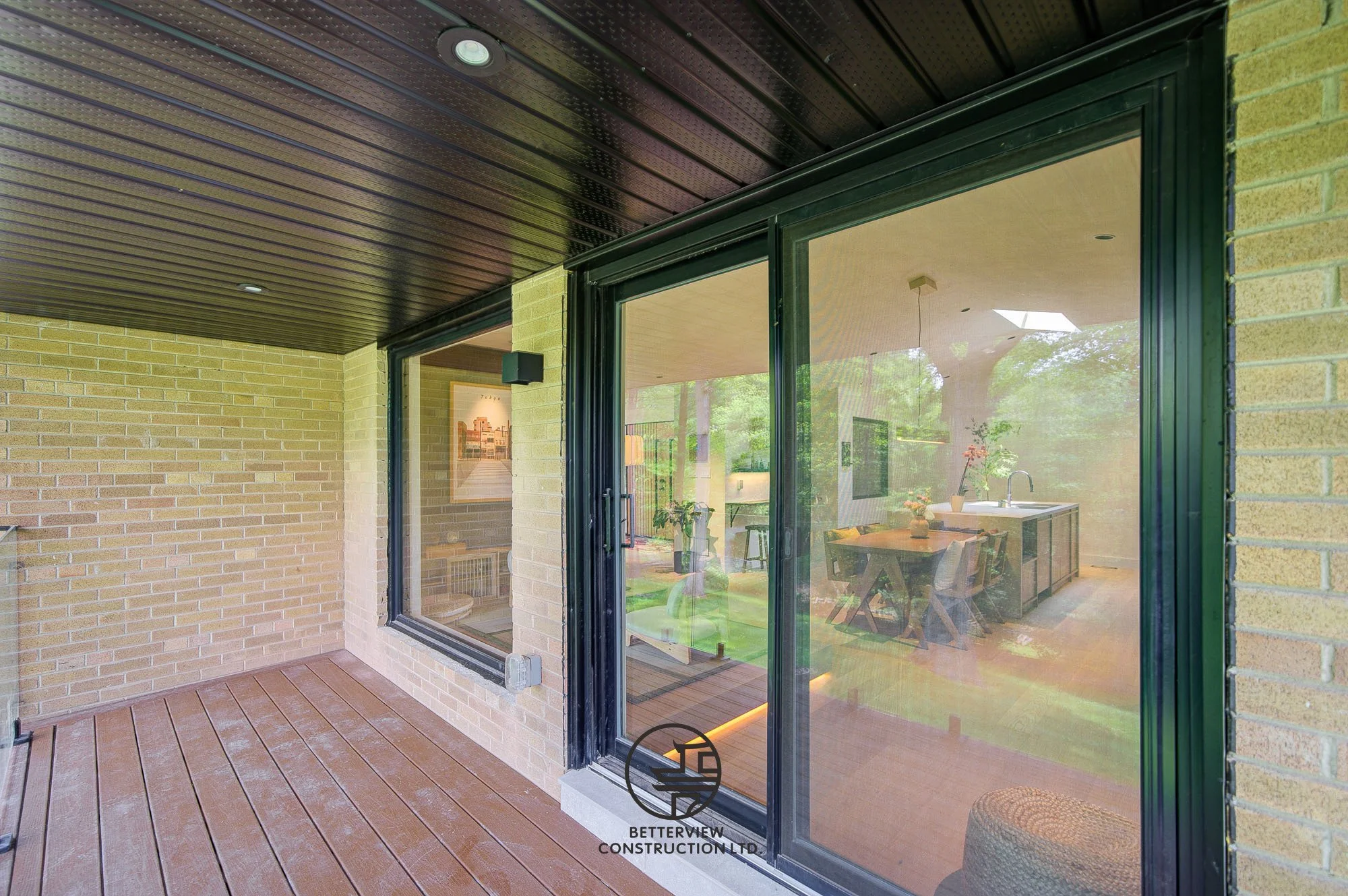 backyard deck with sliding glass doors connecting to kitchen