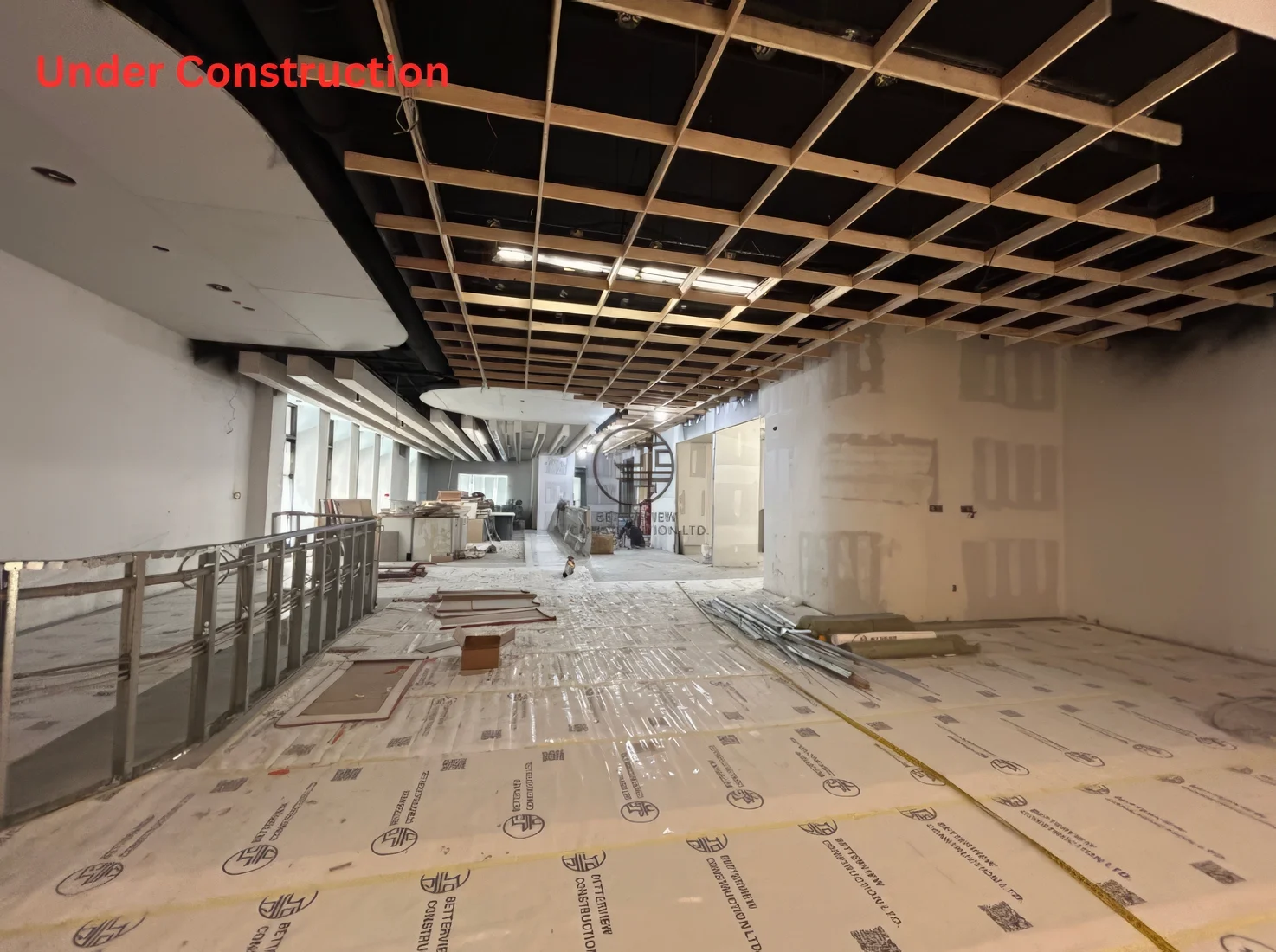 Restaurant renovation under construction in Toronto showing ceiling framework installation, open interior layout, and ongoing commercial build-out