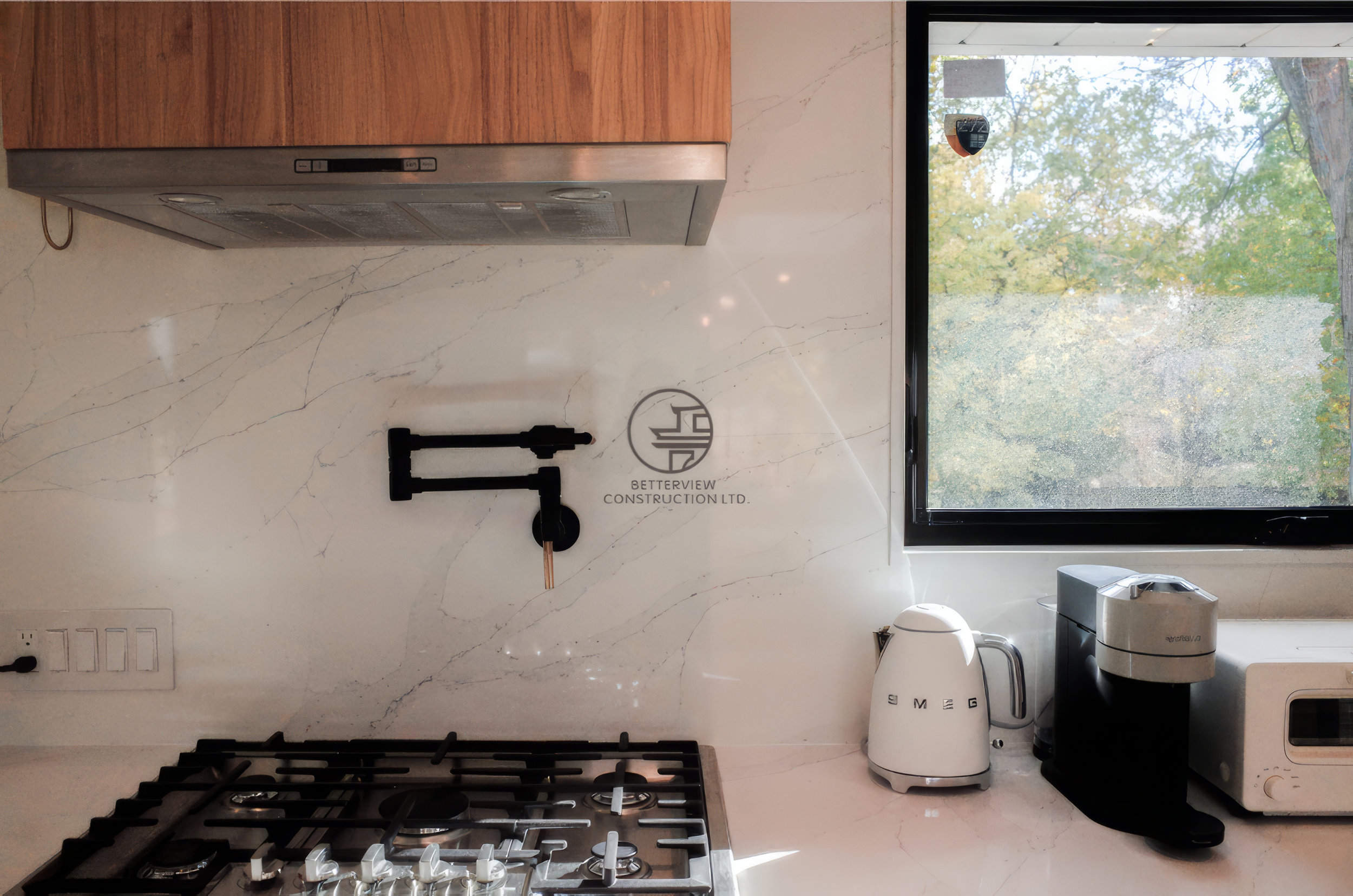 Modern kitchen renovation with gas cooktop, marble backsplash, and custom wood cabinetry in a Toronto home.