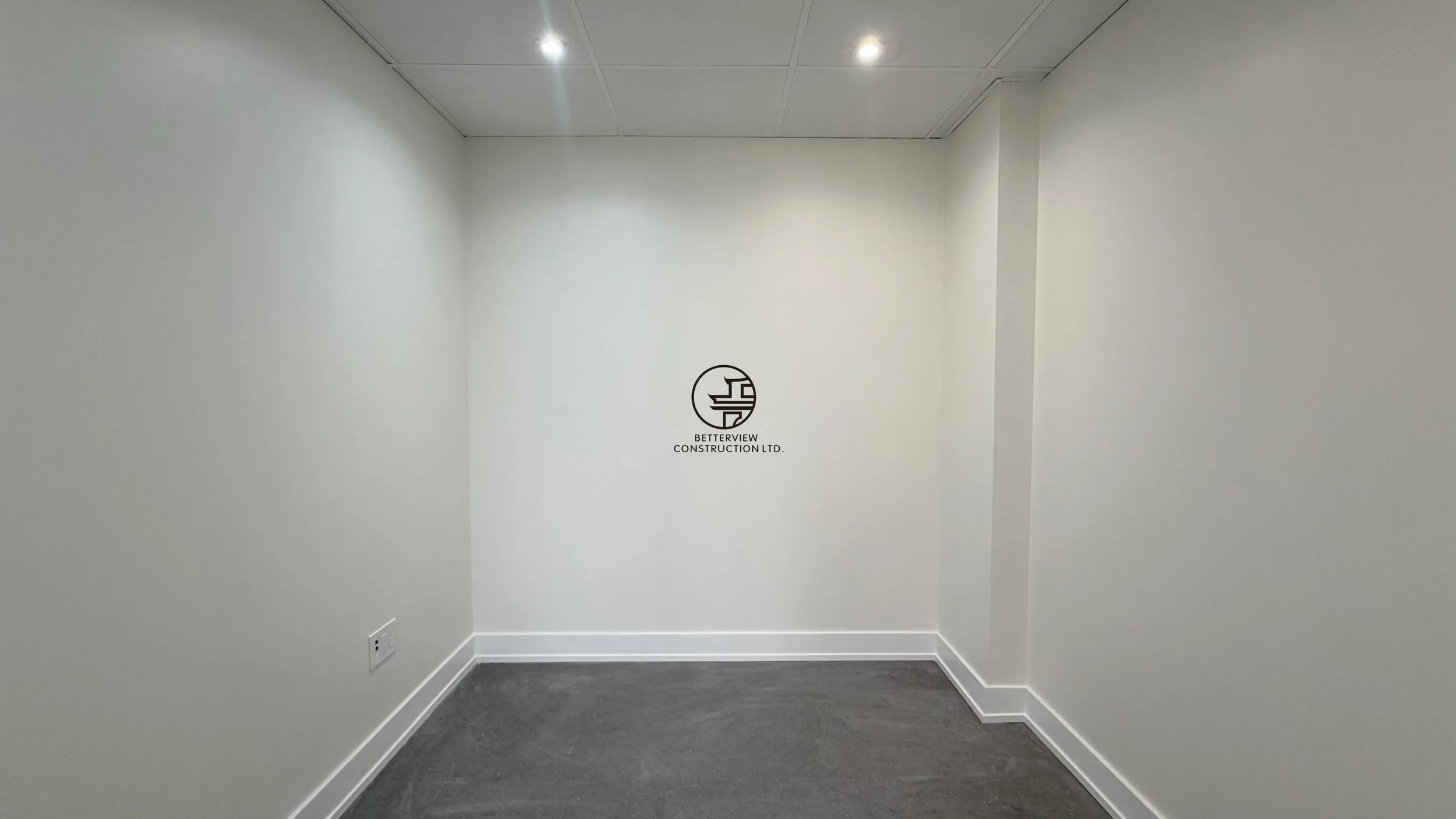 Empty private office room with carpet flooring, recessed lighting, and clean modern interior after renovation