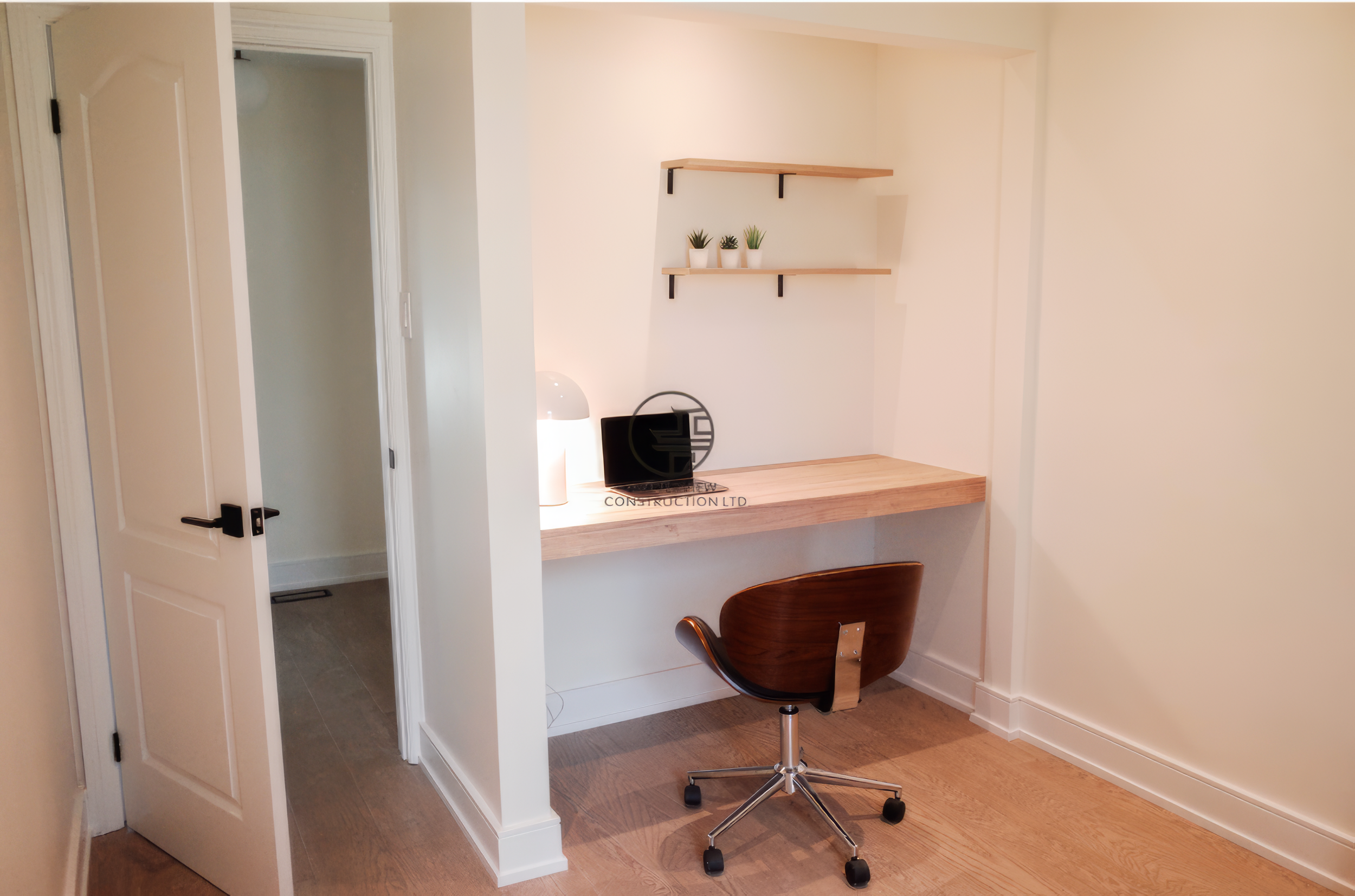 Modern home office nook renovation with built-in desk, floating shelves, and minimalist workspace design in a Toronto home.