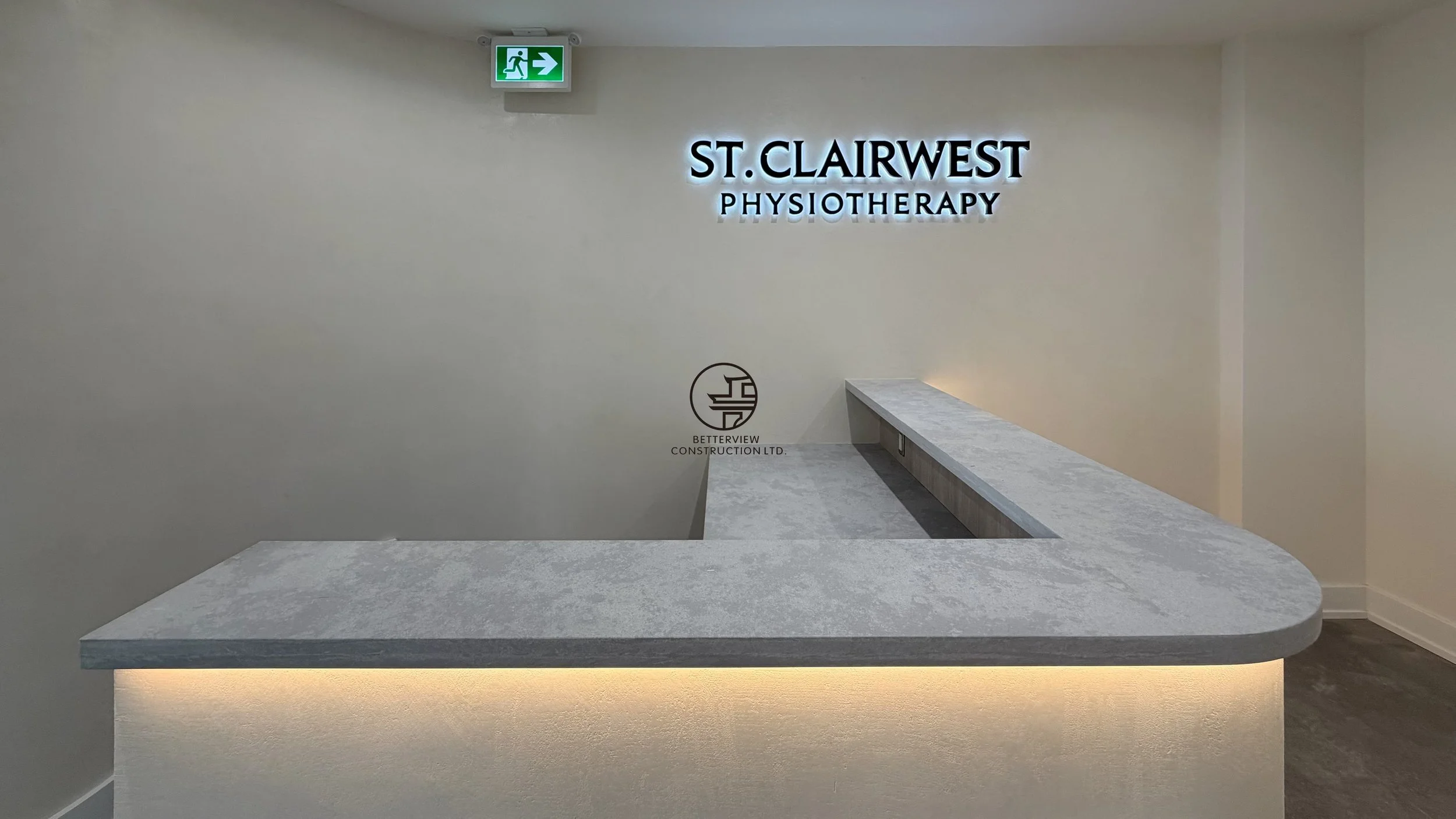 Modern reception desk with custom counter, backlit design, and clinic interior renovation for physiotherapy office