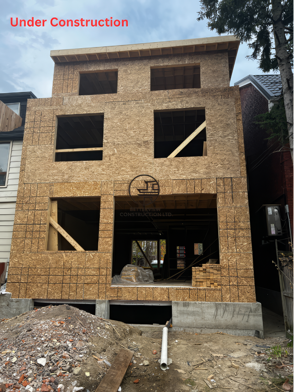 Under construction new build home with full wood framing, large window openings, and front elevation structure in a residential construction project