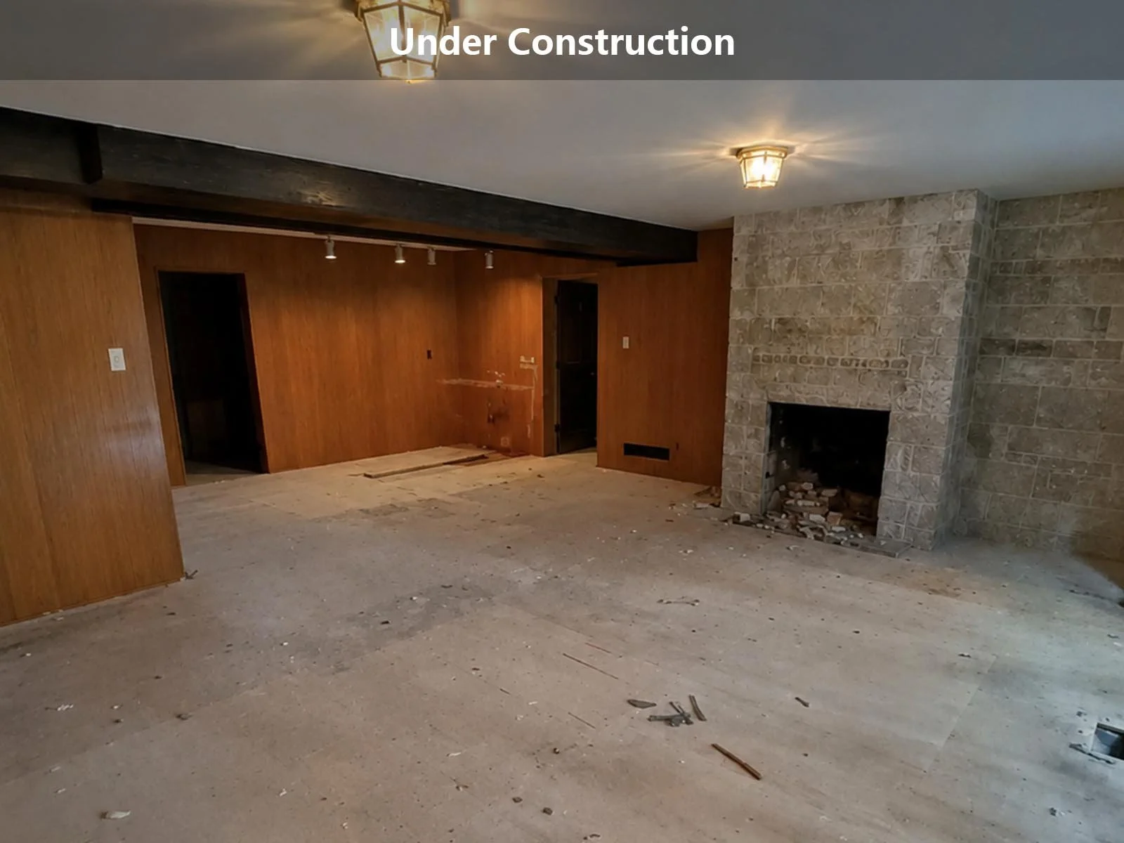 living room renovation under construction with exposed floor and fireplace