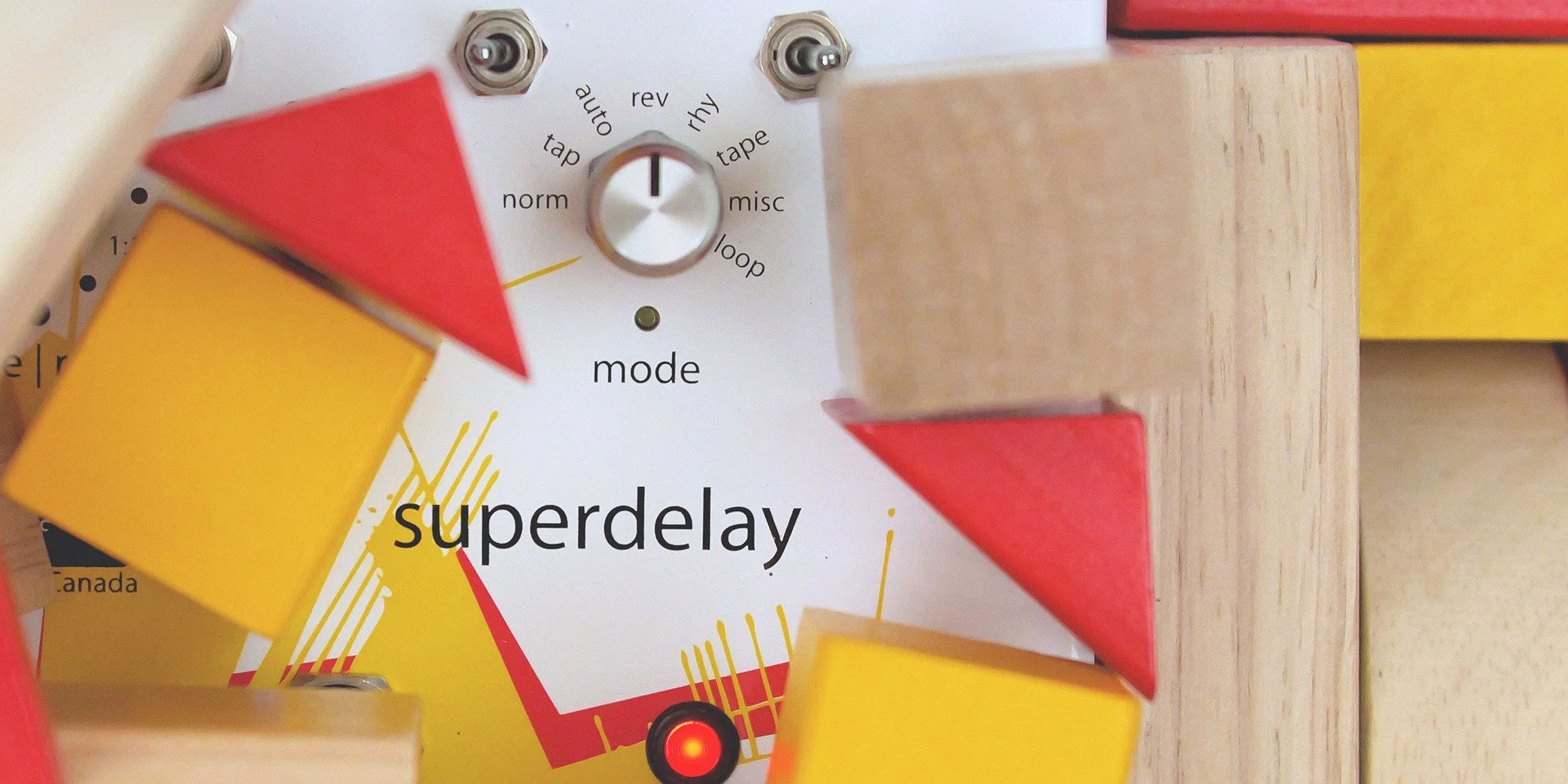 Superdelay pedal by Empress Effects surrounded by toy blocks.