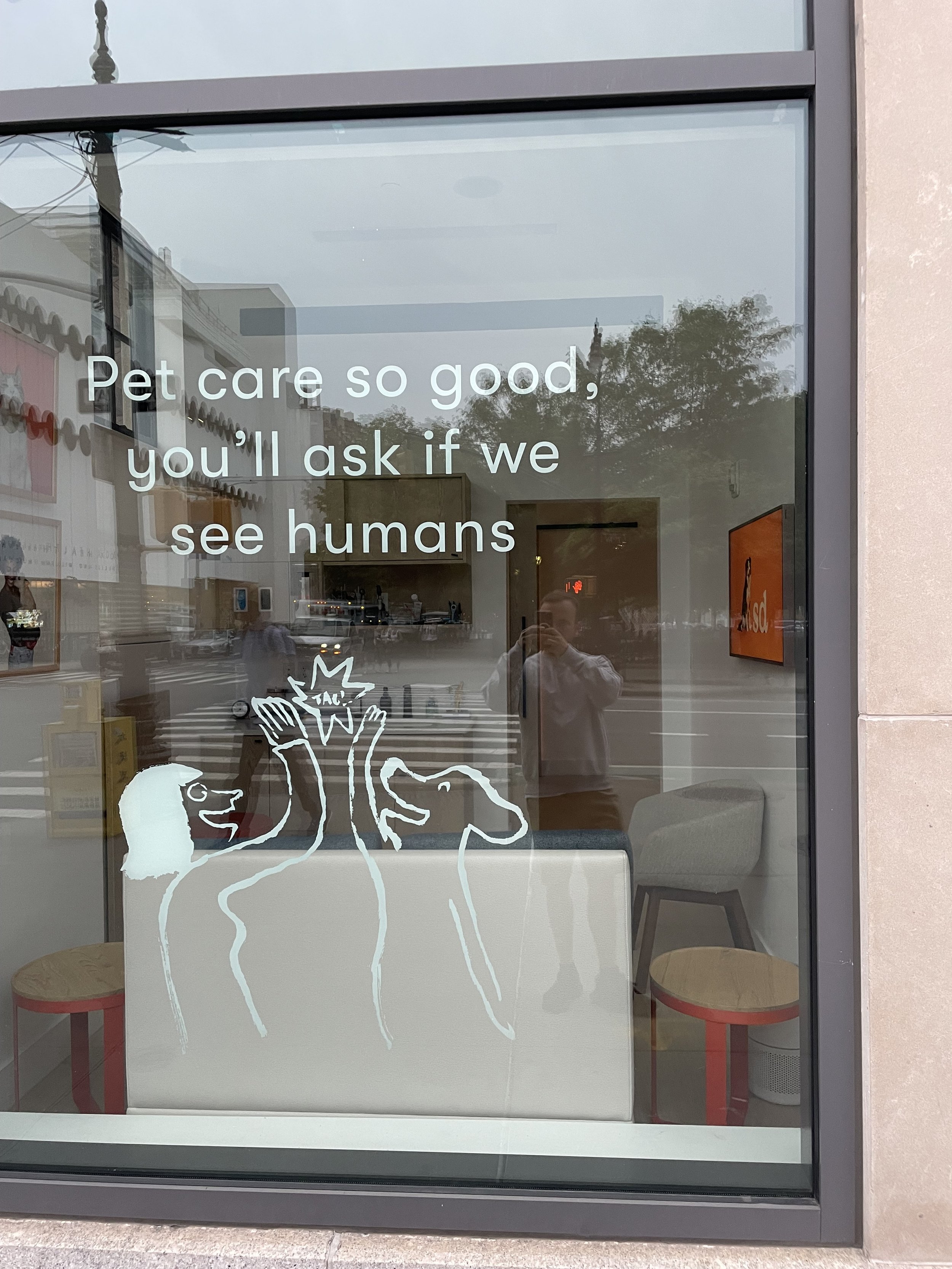 Window sign that says 'Pet care so good, you'll ask if we see humans'