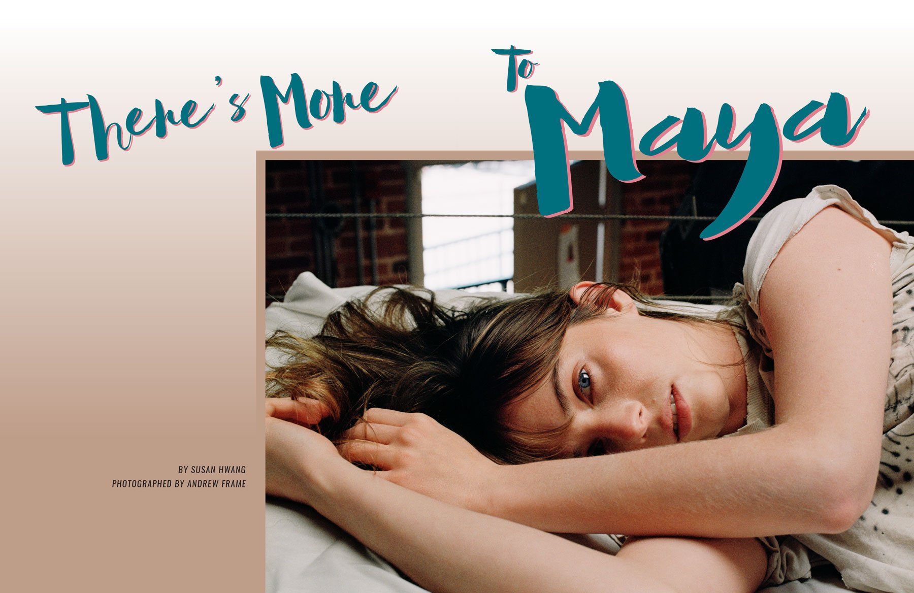 A woman with brown hair and blue eyes lying on a bed, resting her head on her arm, with a relaxed expression. The background shows brick walls and a window with daylight streaming through.