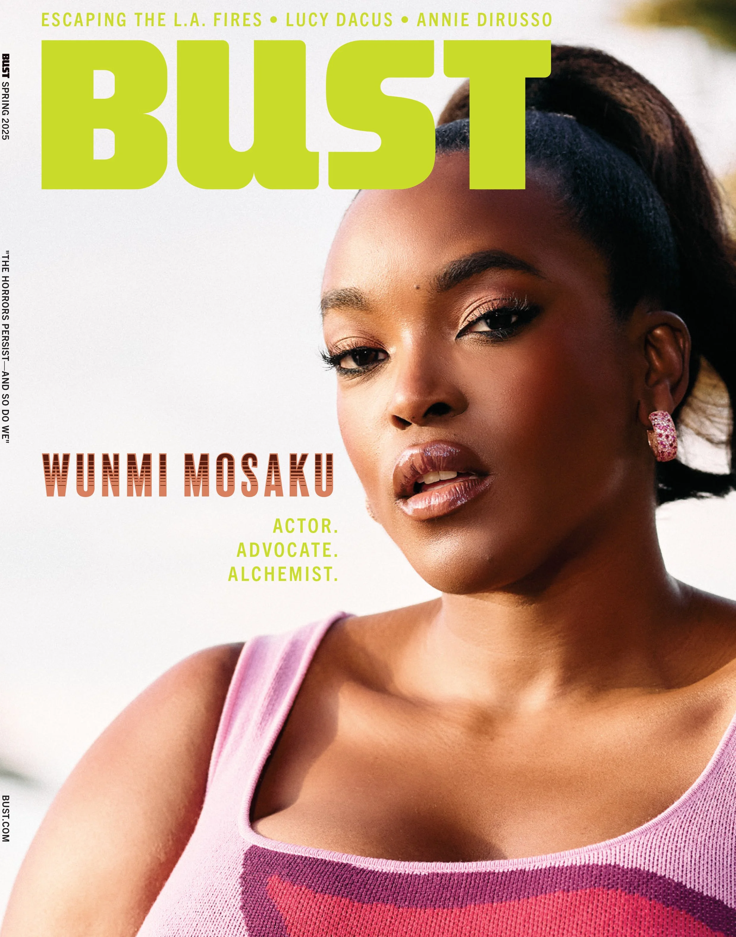 Cover of Bust magazine featuring Wunmi Mosaku, an African American actress. She is wearing pink lipstick, pink and purple earrings, and a pink top with purple and red design. The magazine includes headlines about her roles as actor, advocate, and alchemist.
