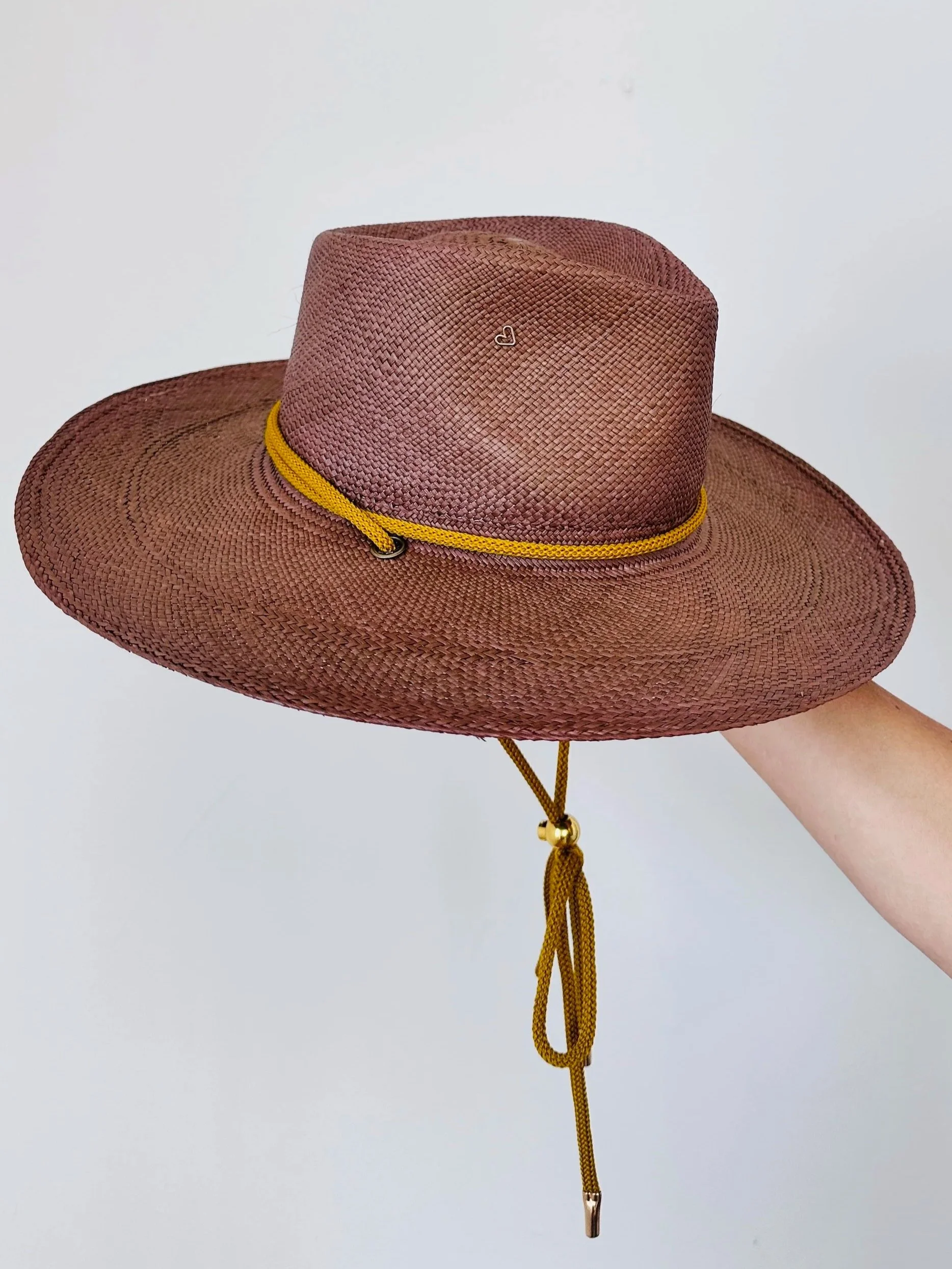 custom designed heirloom straw hat with personalized crown shape in hat studio
