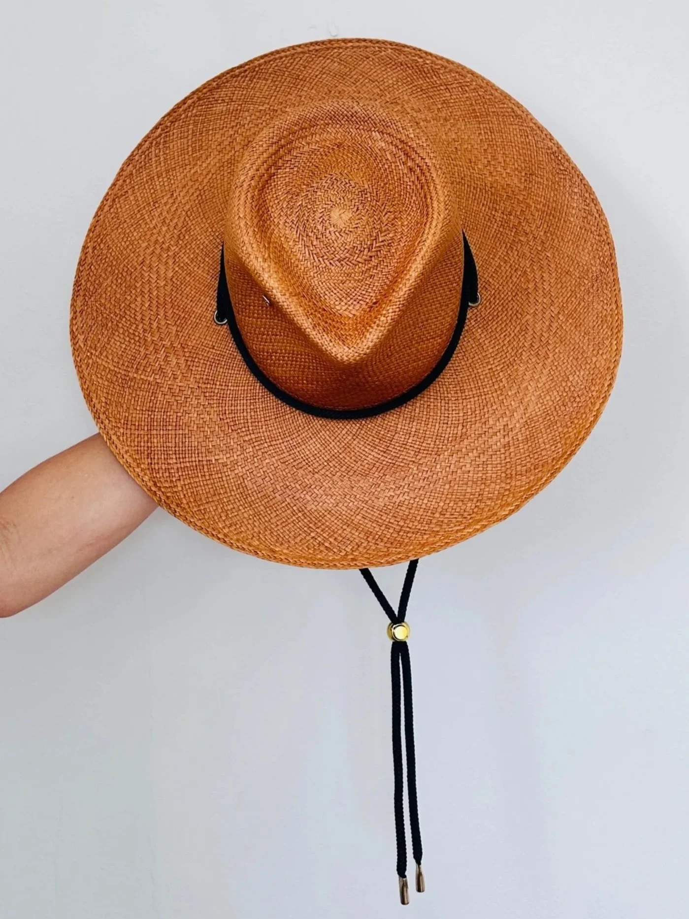 custom designed heirloom straw hat with personalized crown shape in hat studio