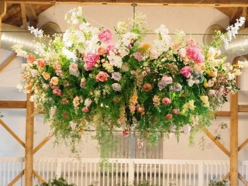 Hanging floral chandelier designed by Wild Flora Flowers at The Barn of Chapel Hill wedding venue in Chapel Hill, North Carolina