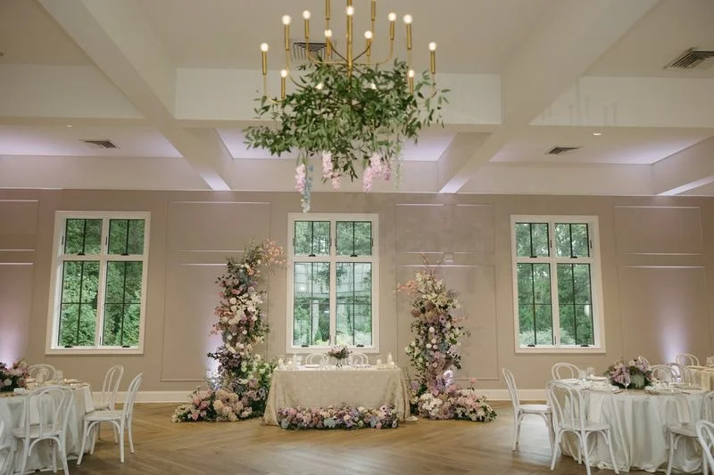 Wedding reception floral installations at The Bradford featuring statement arrangements and head table flowers by Wild Flora Flowers.