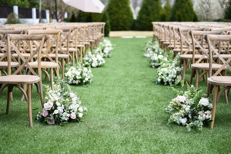 Wedding ceremony aisle at The Bradford lined with ground floral arrangements by Wild Flora Flowers.