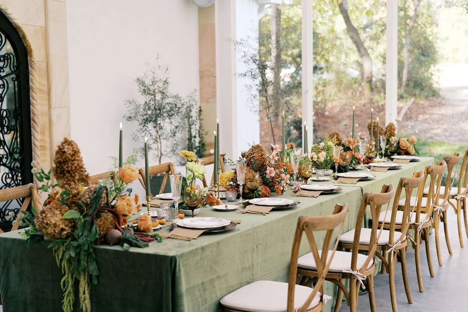Elegant modern fall tablescape styled with dried flowers and soft candlelight