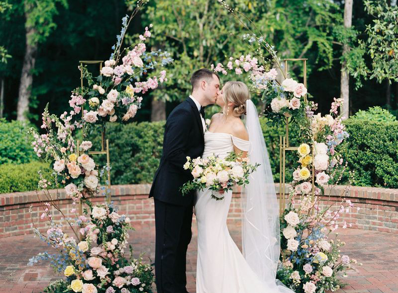 Pastel-colored modern flower arch designed for a wedding ceremony