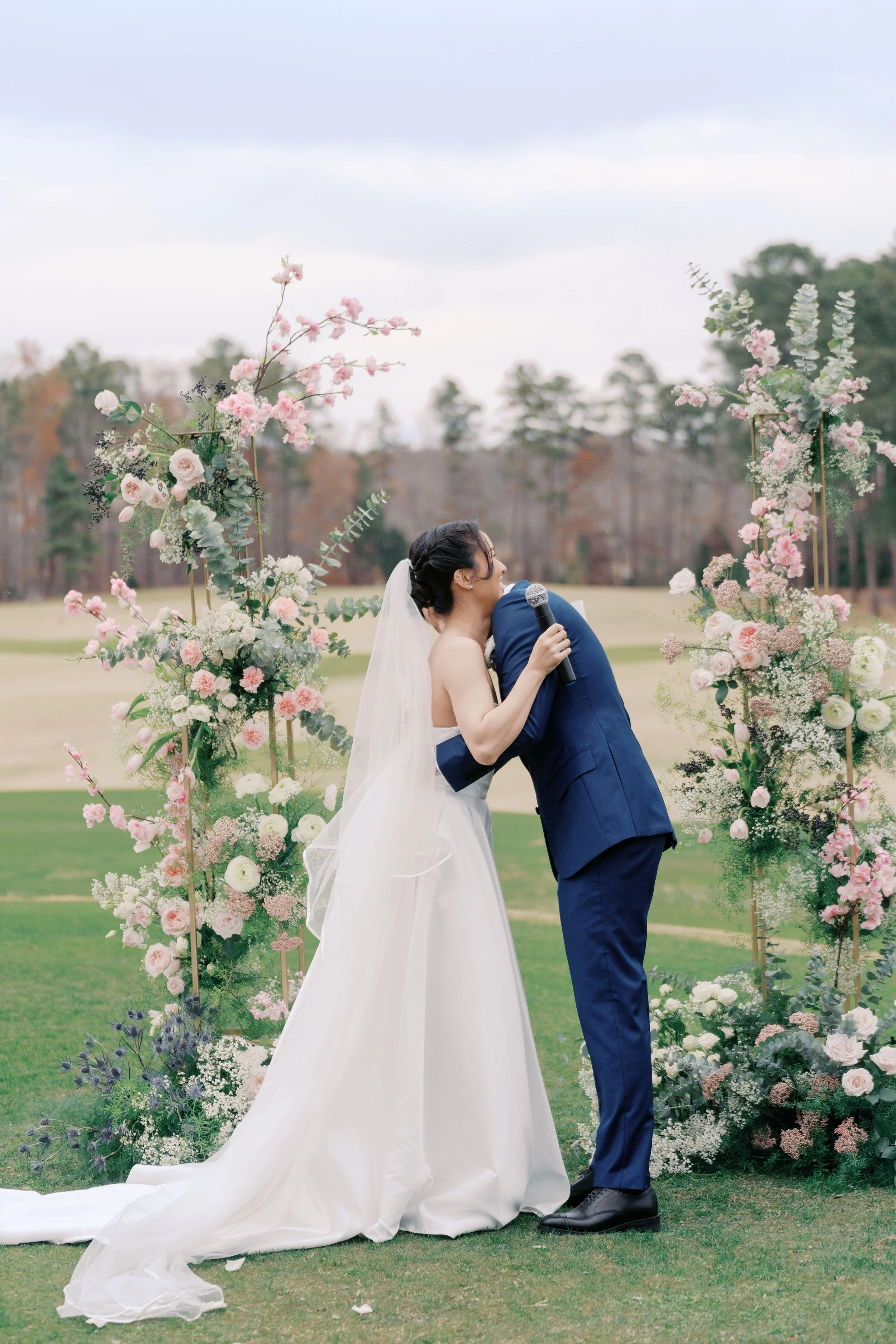 Pink and white floral wedding arch with soft, romantic blooms