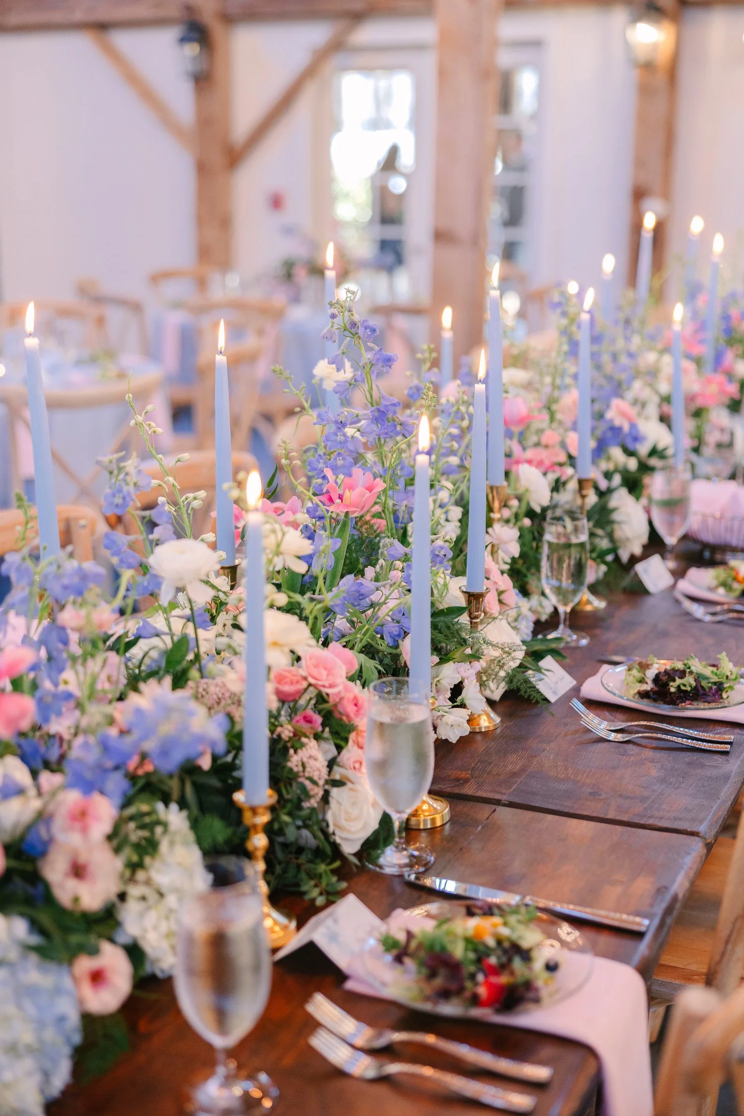 Modern pastel flower tablescape styled with blue taper candles by Wild Flora