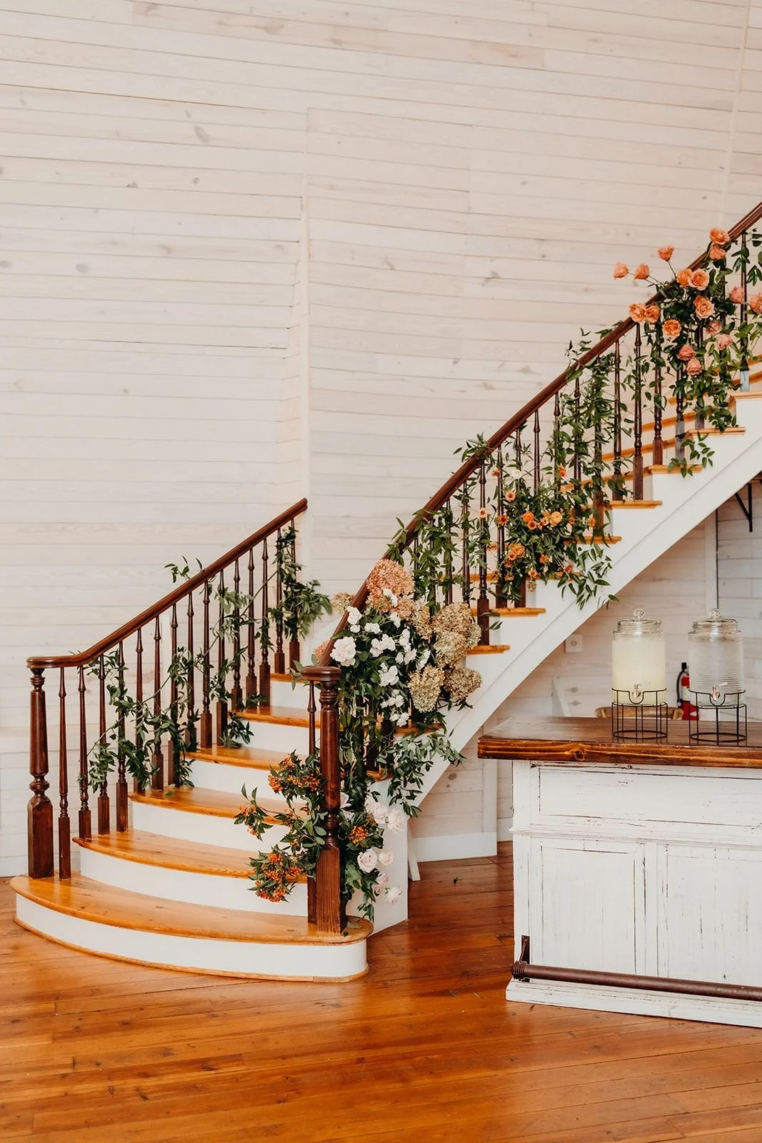 Elegant autumn wedding reception with a grand staircase florals