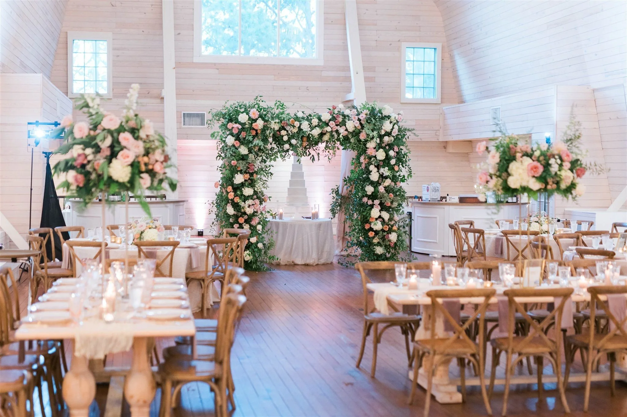 Luxury wedding flowers in pink and white inside a historic barn venue