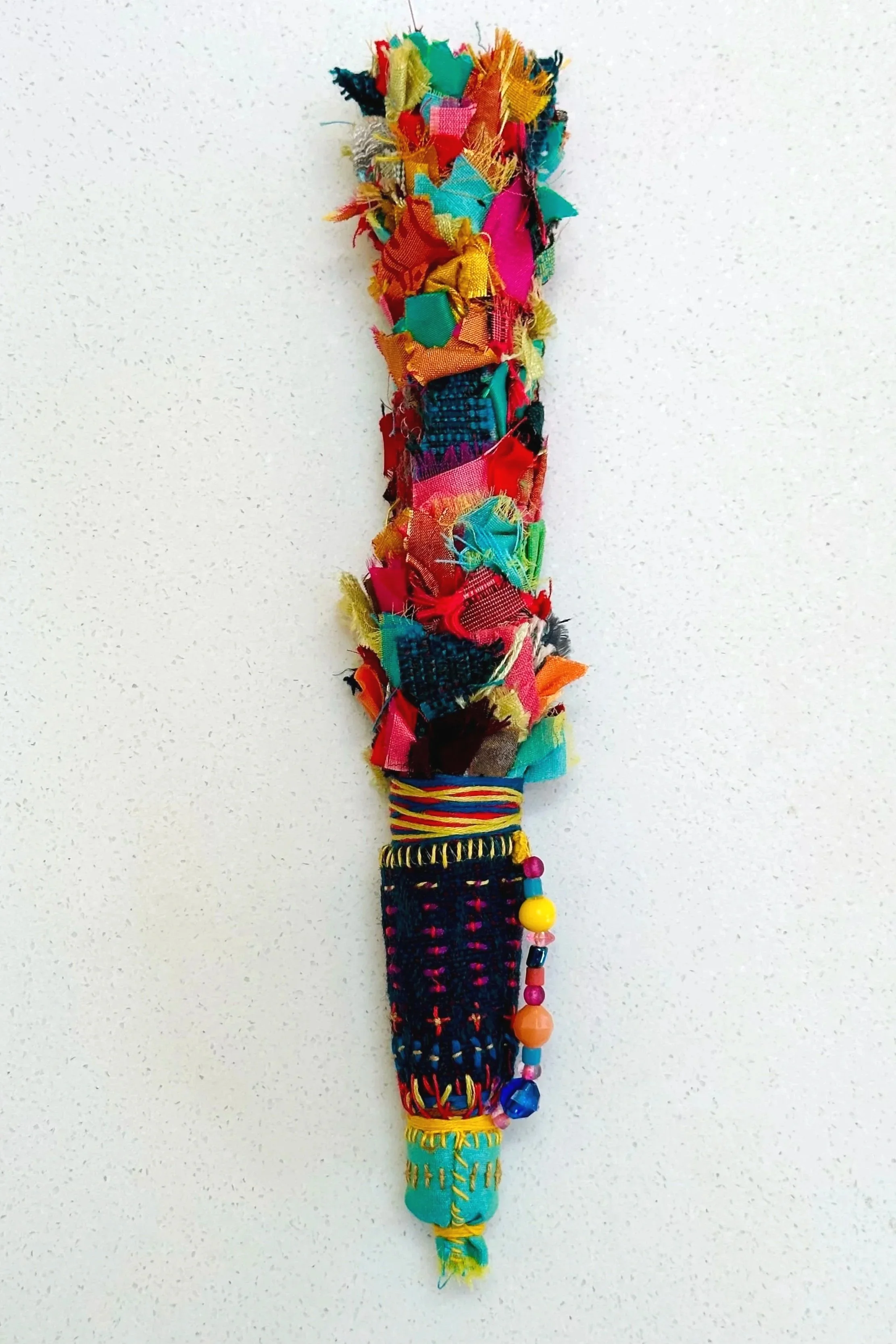 Torch   (2025)   felt, upcycled fabric, beads, Sashiko thread, embroidery thread   10" x 2" x 2"   