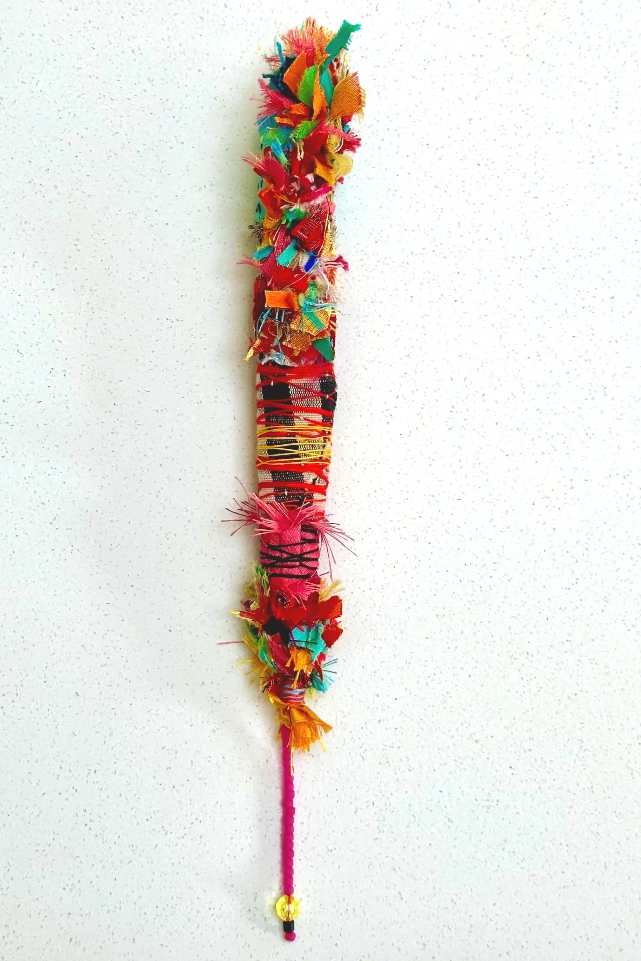 Living Torch   (2025)   felt, upcycled fabric, beads, Sashiko thread, embroidery thread   12" x 2" x 2.5"   