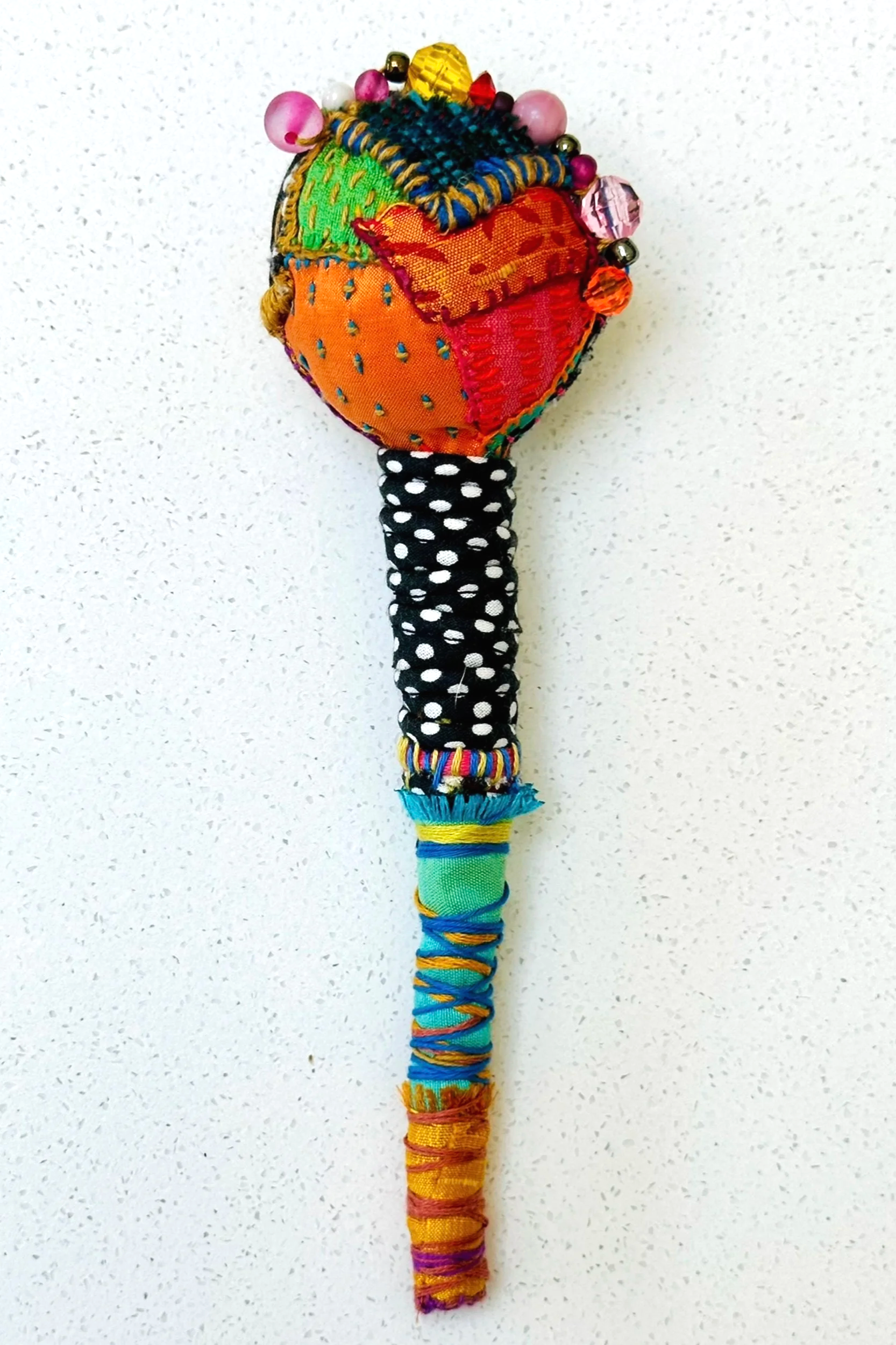Another Turn   (2025)   felt, upcycled fabric, beads, Sashiko thread, embroidery thread   8.5" x 2" x 2"  
