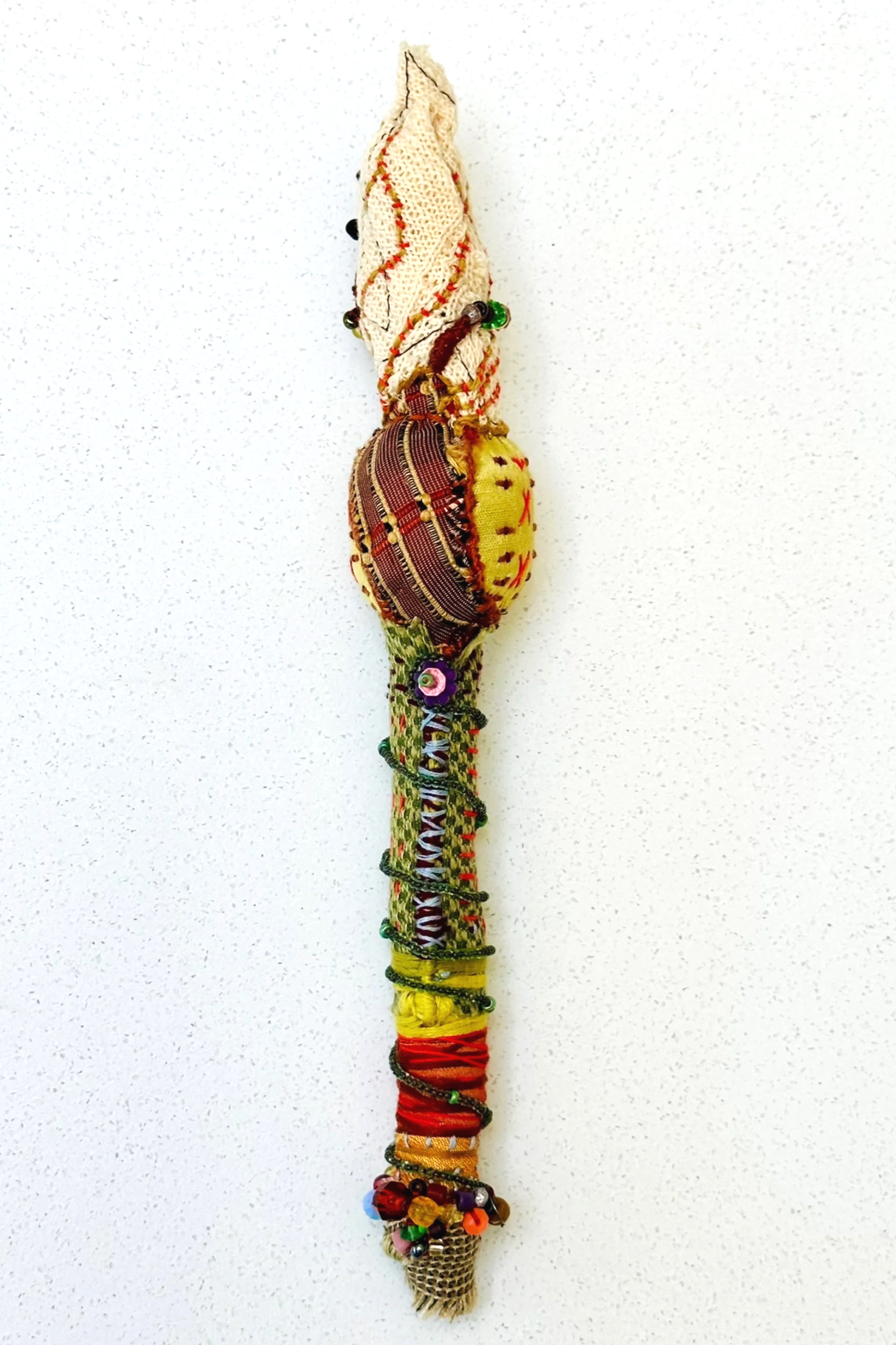 Another Pondering   (2025)   felt, upcycled fabric, beads, Sashiko thread, embroidery thread   10.5" x 2" x 2"  