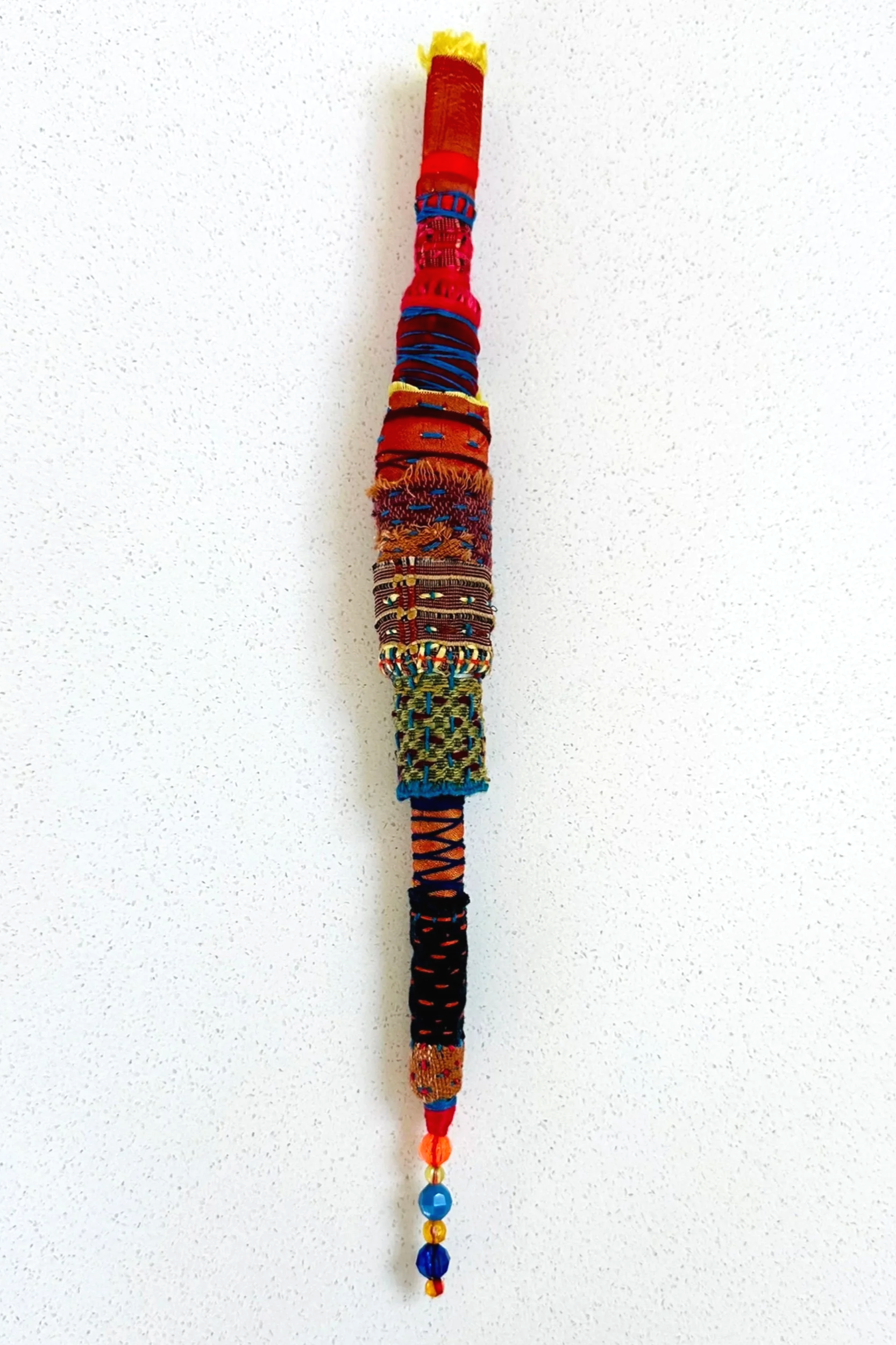 Another Experiment...   (2025)   felt, upcycled fabric, beads, Sashiko thread, embroidery thread   12" x 1" x 1"  