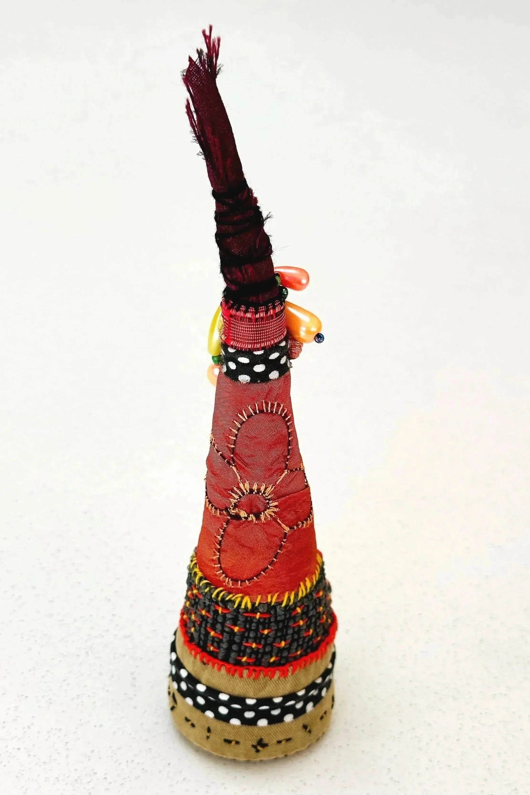 Burnt Orange Concentration   (freestanding)   (2025)   felt, upcycled fabric, beads, Sashiko thread, embroidery thread   8" x 2" x 2.5"   