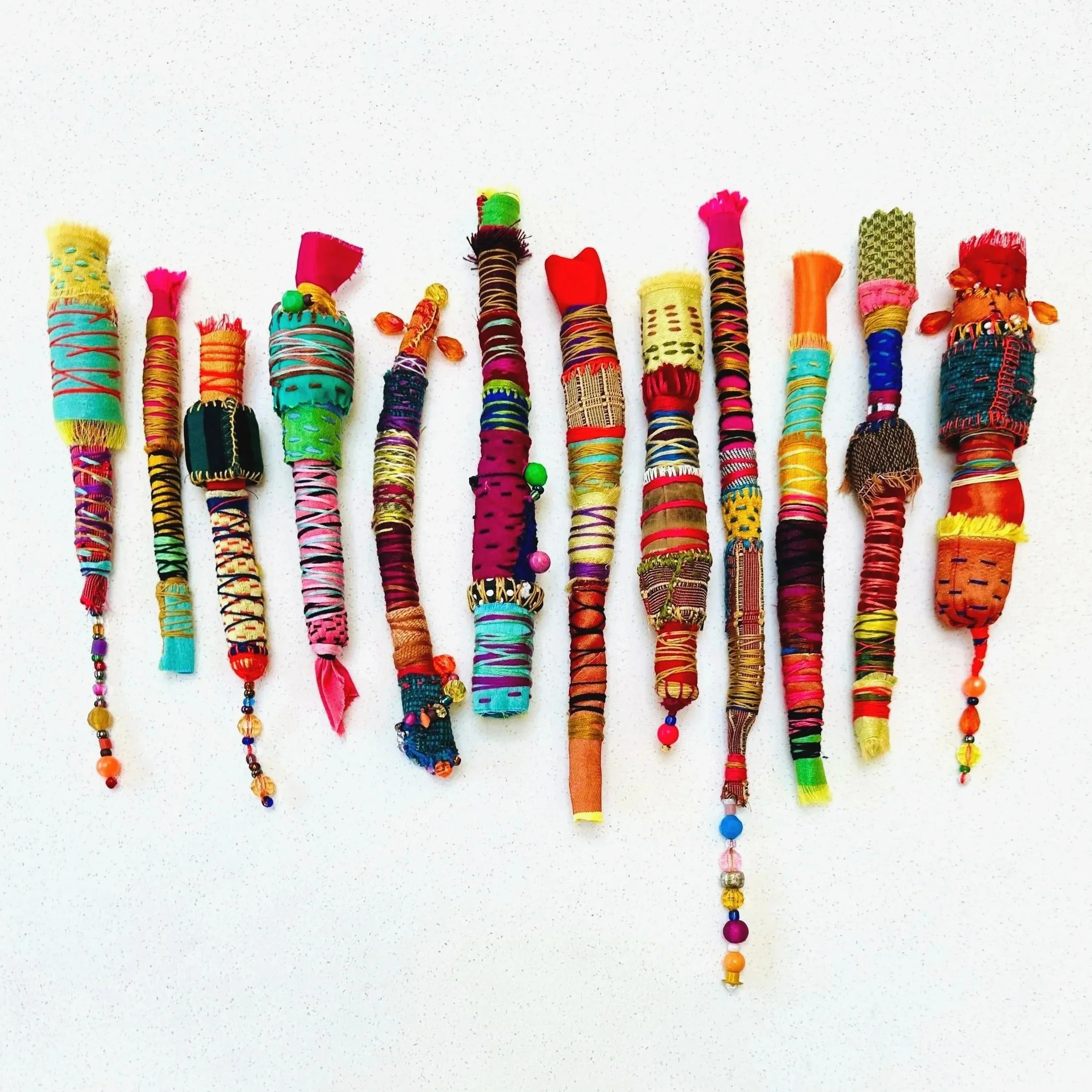 Exploration in Progress   (2025)   felt, upcycled fabric, beads, Sashiko thread, embroidery thread   6" - 12" x 1"   