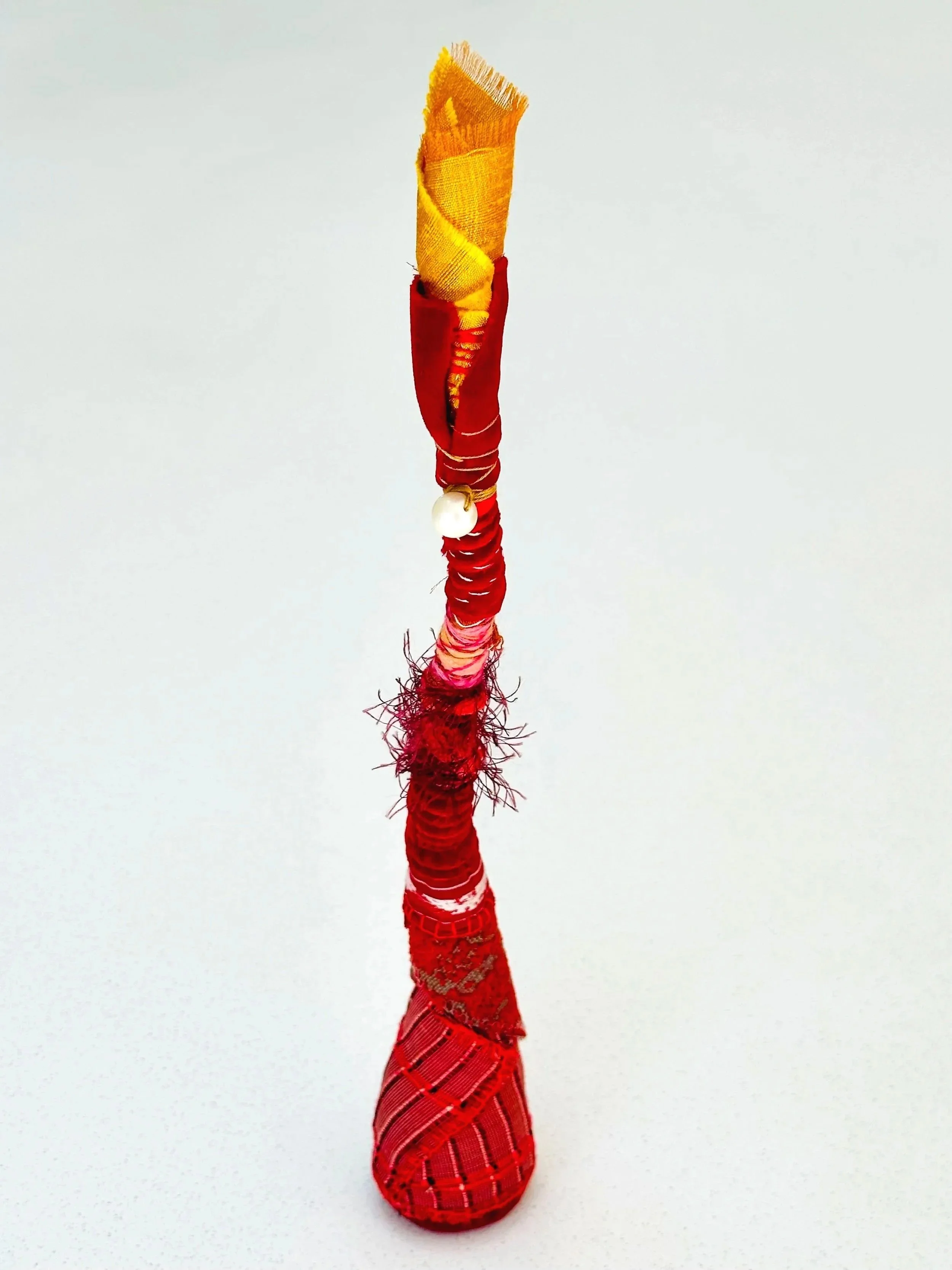 Cinnamon Heat   (freestanding)   (2025)   felt, upcycled fabric, Sashiko thread, embroidery thread, yarn   13" x 5" x 2.5"  $400