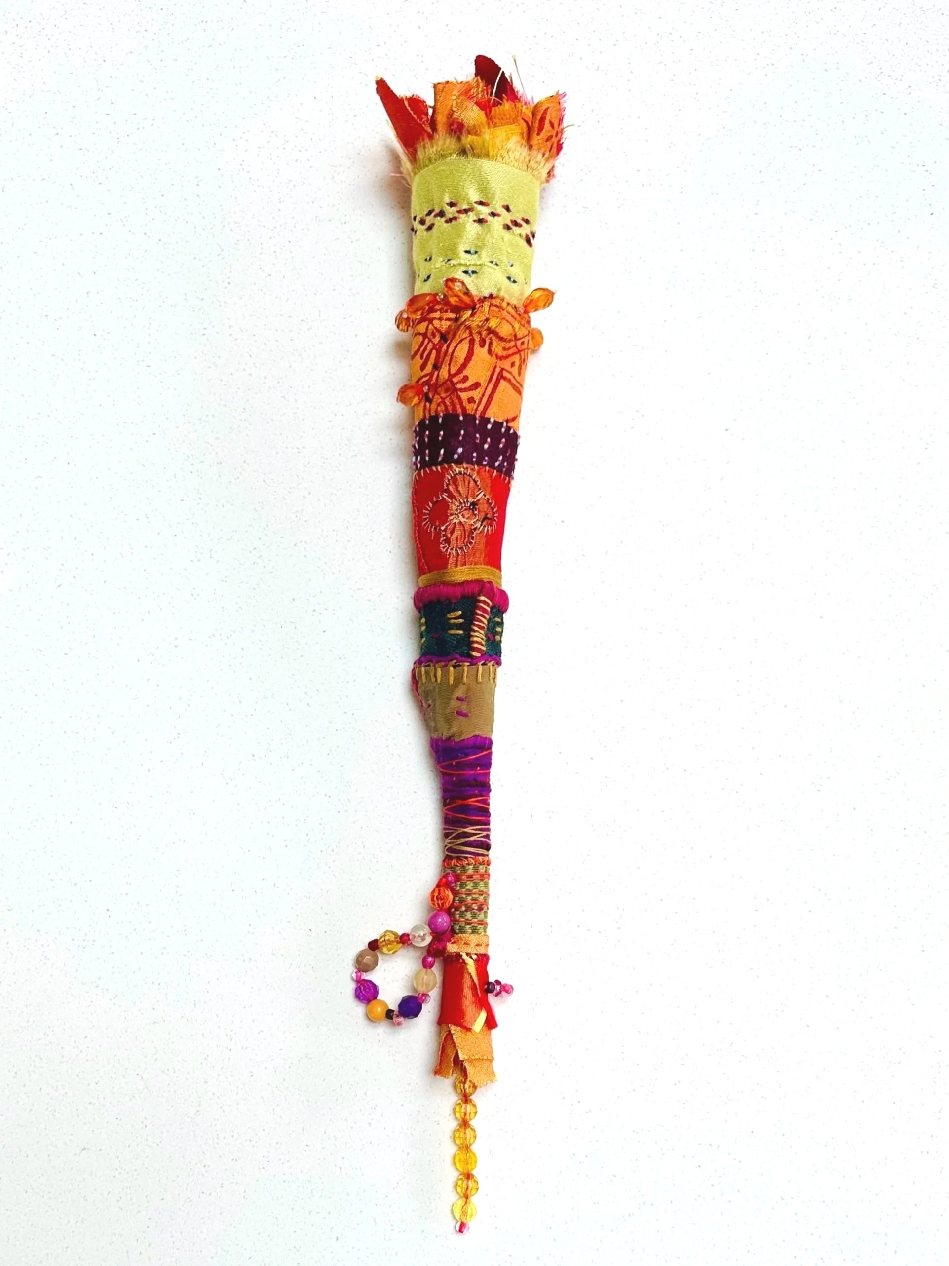 Holding the Flame High   (2025)   felt, upcycled fabric, beads, Sashiko thread, embroidery thread   16" x 2.5" x 2.5"  $600