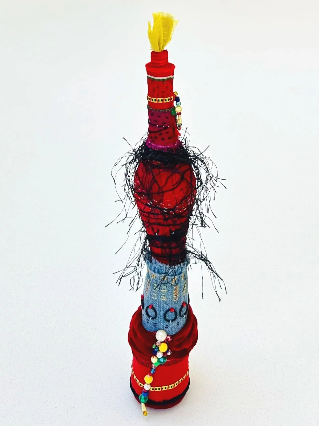 Layered Overlapping Convo (in my head)  (freestanding)   (2025)   felt, upcycled fabric, Celsa's old jeans, trim, yarn, Sashiko thread, embroidery thread, o-rings  15" x 3.5" x 3.5"  $450