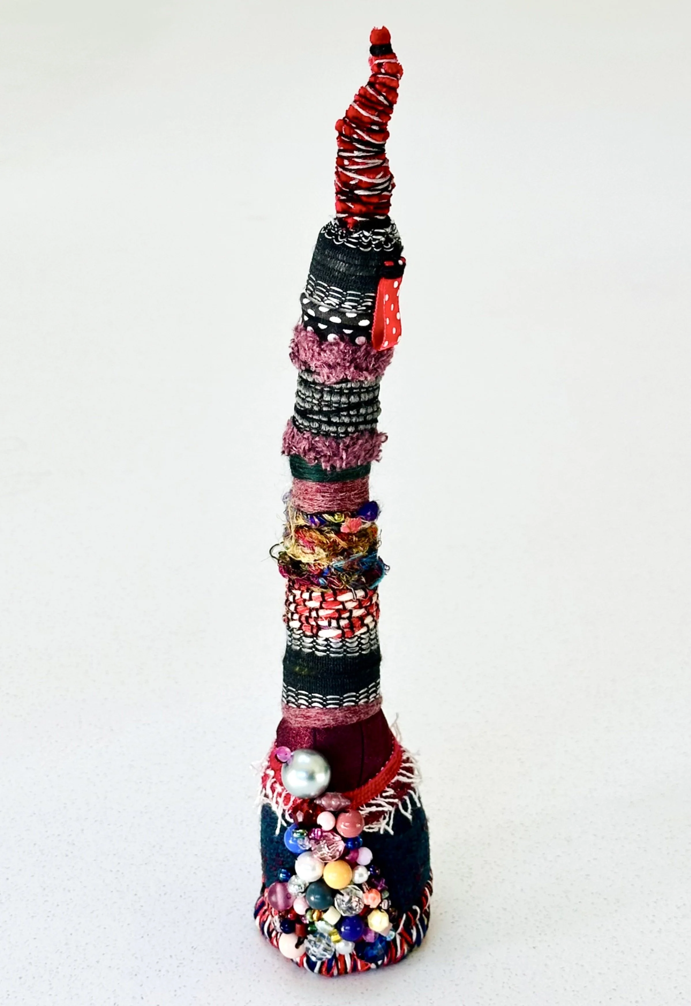 Corseted  (freestanding)   (2025)   felt, upcycled fabric, trim, Sashiko thread, embroidery thread, yarn  10" x 2" x 2.5"  $450