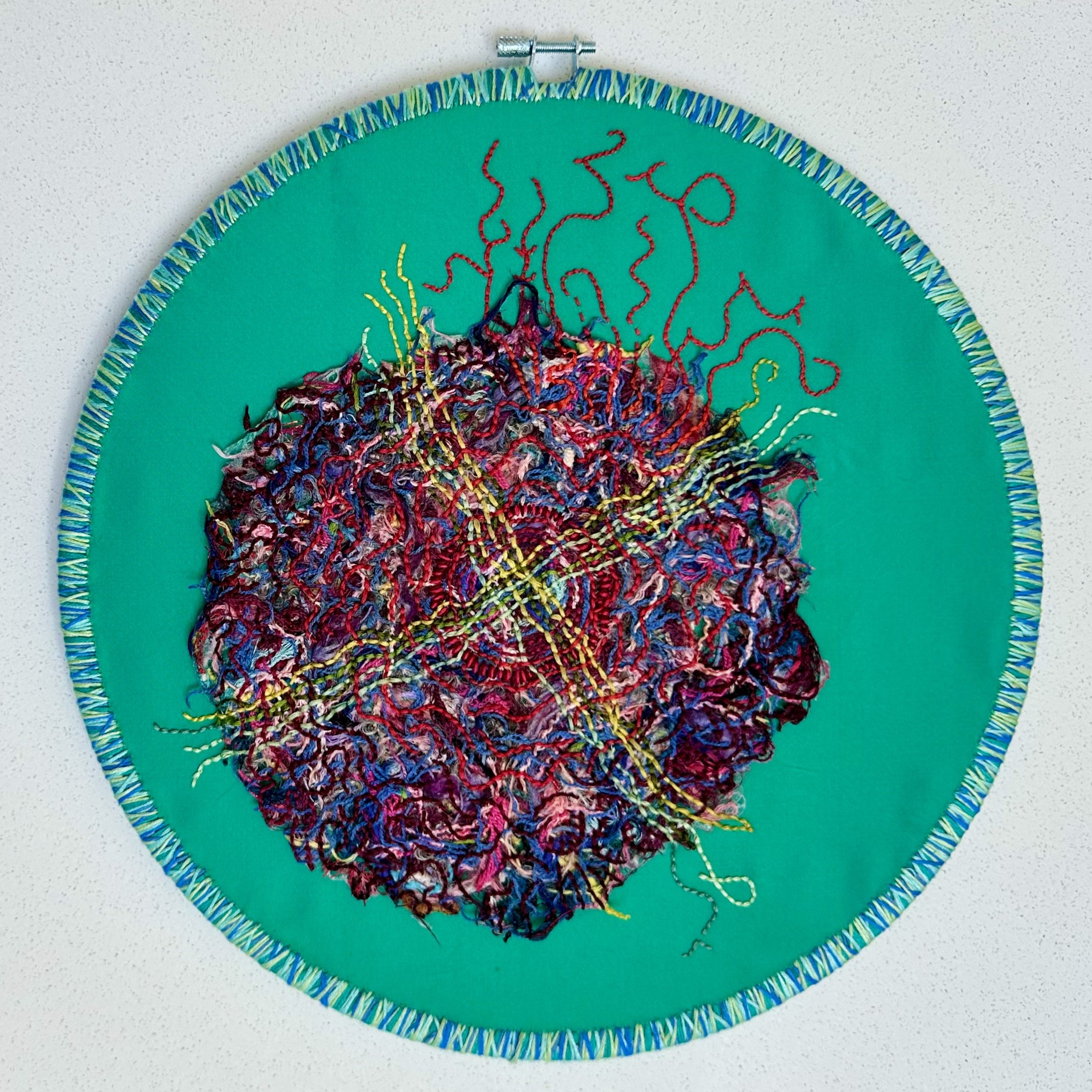 Tangled Webs and Solar Flares (2024) emboidery thread on upcycled fabric 12" disc $